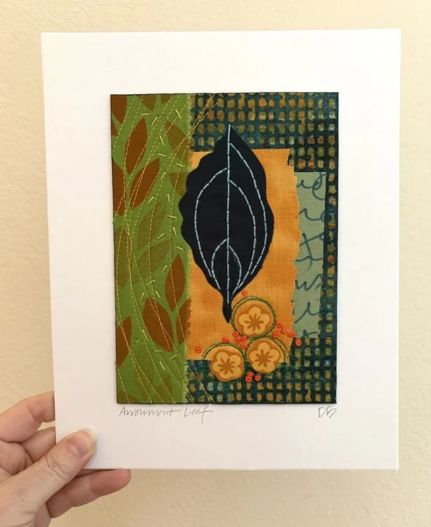 Mixed media artwork titled 'Arrowroot Leaf' featuring an abstract leaf design with decorative elements and vibrant colors.