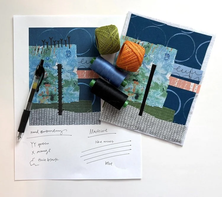Artistic fabric pieces with colorful yarn balls, placed on sketches of abstract landscapes, alongside a pen and handwritten notes.