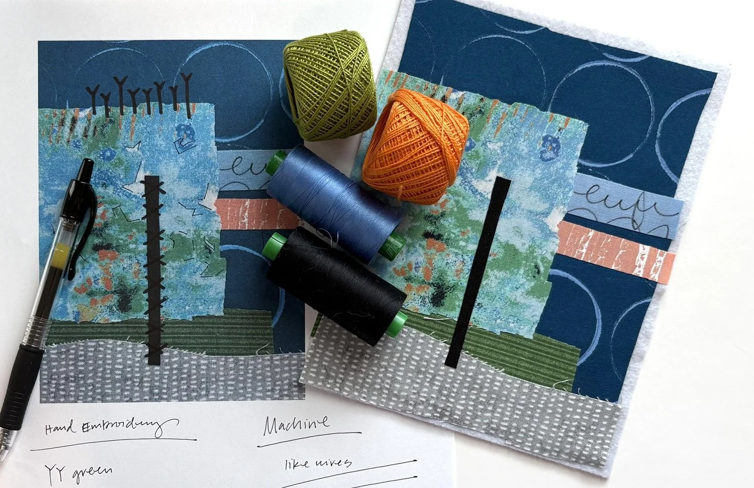 Two embroidered fabric pieces with abstract landscape designs, spools of blue, black, and green thread, balls of green and orange yarn, a black pen, and handwritten notes with fabric swatches and embroidery notes on a white background.