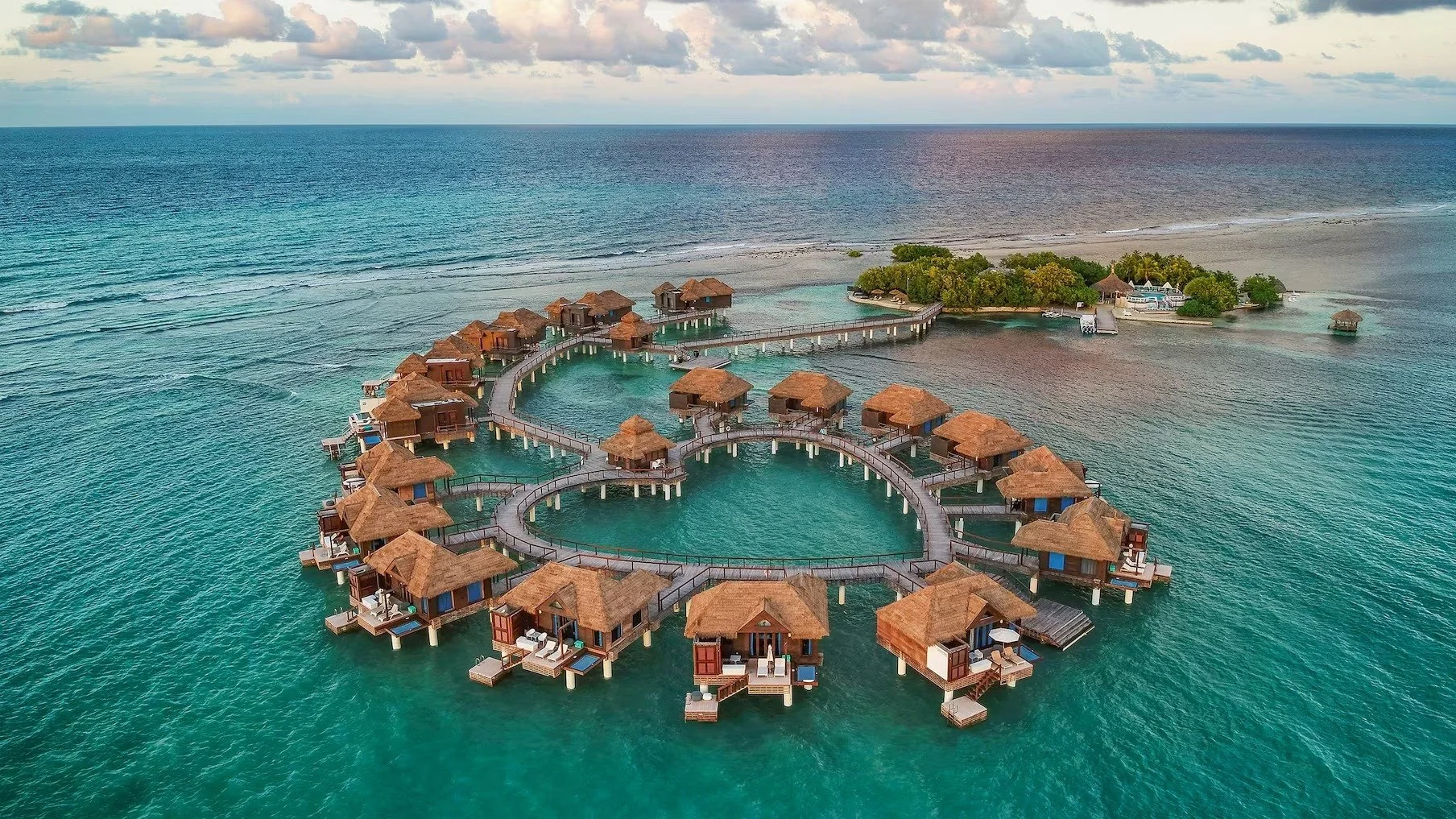 Stop settling for standard luxury when you can experience something truly extraordinary. This is the exclusive, private island at Sandals Royal Caribbean. These iconic Over-the-Water Bungalows offer an unparalleled level of romance and seclusion. Fro
