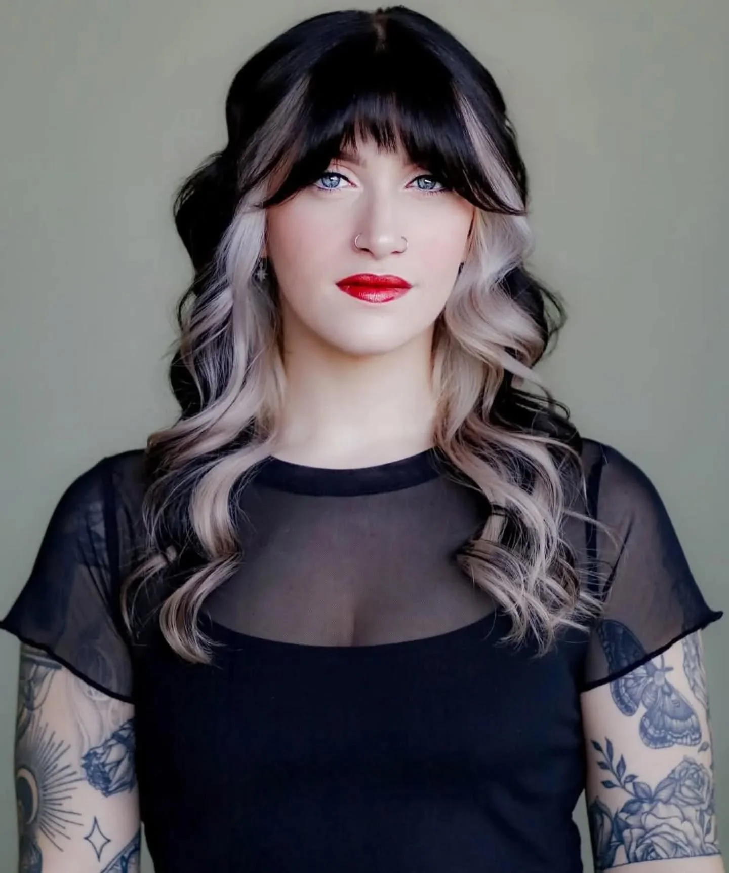 Young woman with curled black and white hair