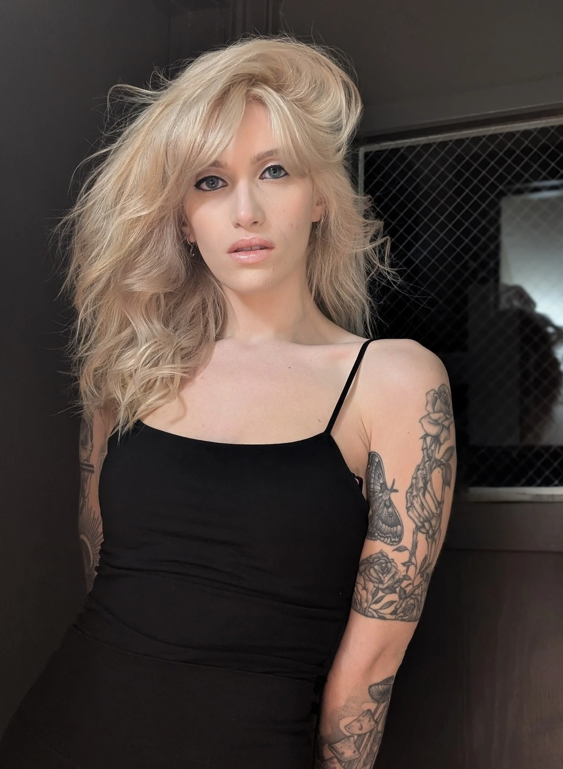 young woman with voluminous, curled, long blonde hair