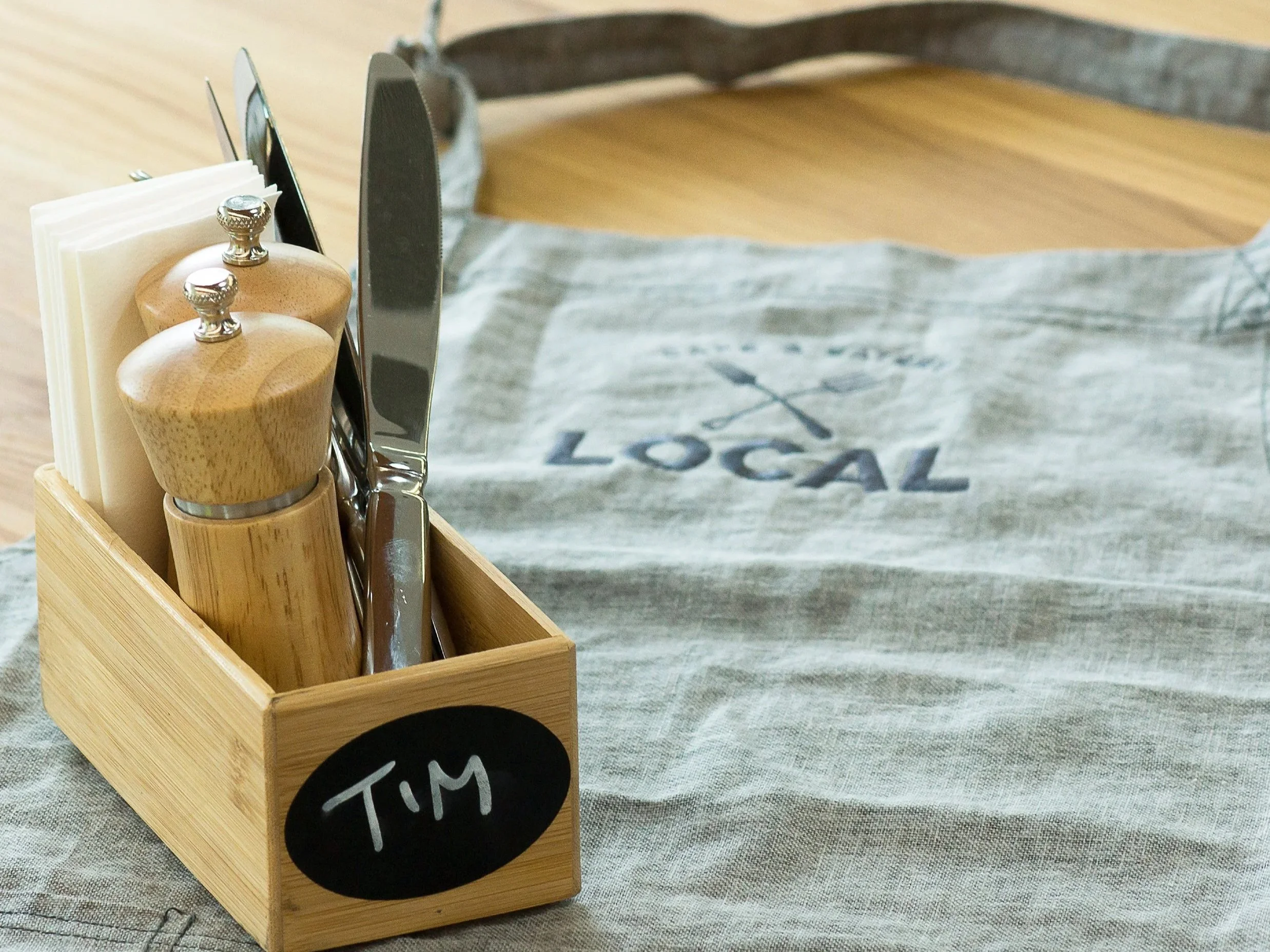 Local branded apron. Branding, hospitality design, interior architecture, designer, Creative Director. Alice Lloyd.