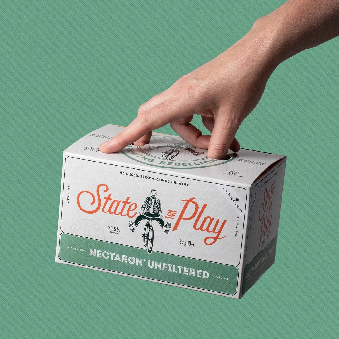 Hand holding box of hazy pale ale. Studio photography, packaging design, branding, designer. Alice Lloyd.