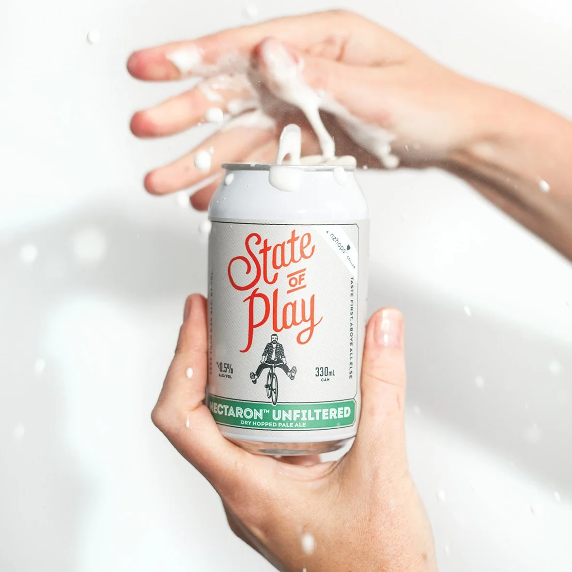 Beer spraying out as can is opened. Studio photography, packaging design, branding, designer. Alice Lloyd.