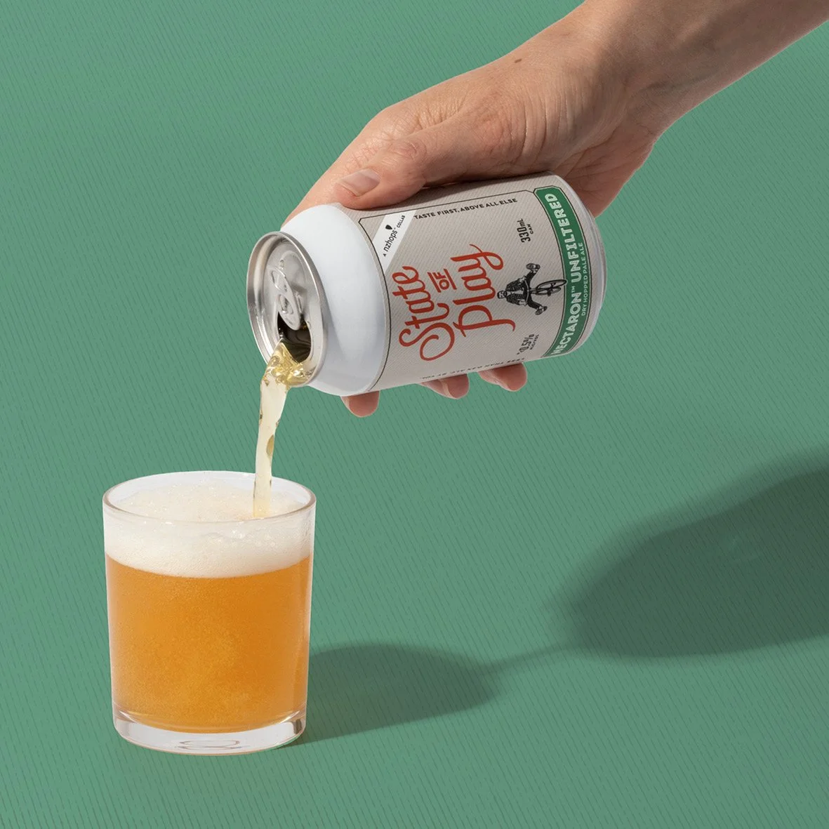 Pouring hazy pale ale from a can into a glass. Studio photography, packaging design, branding, designer. Alice Lloyd.