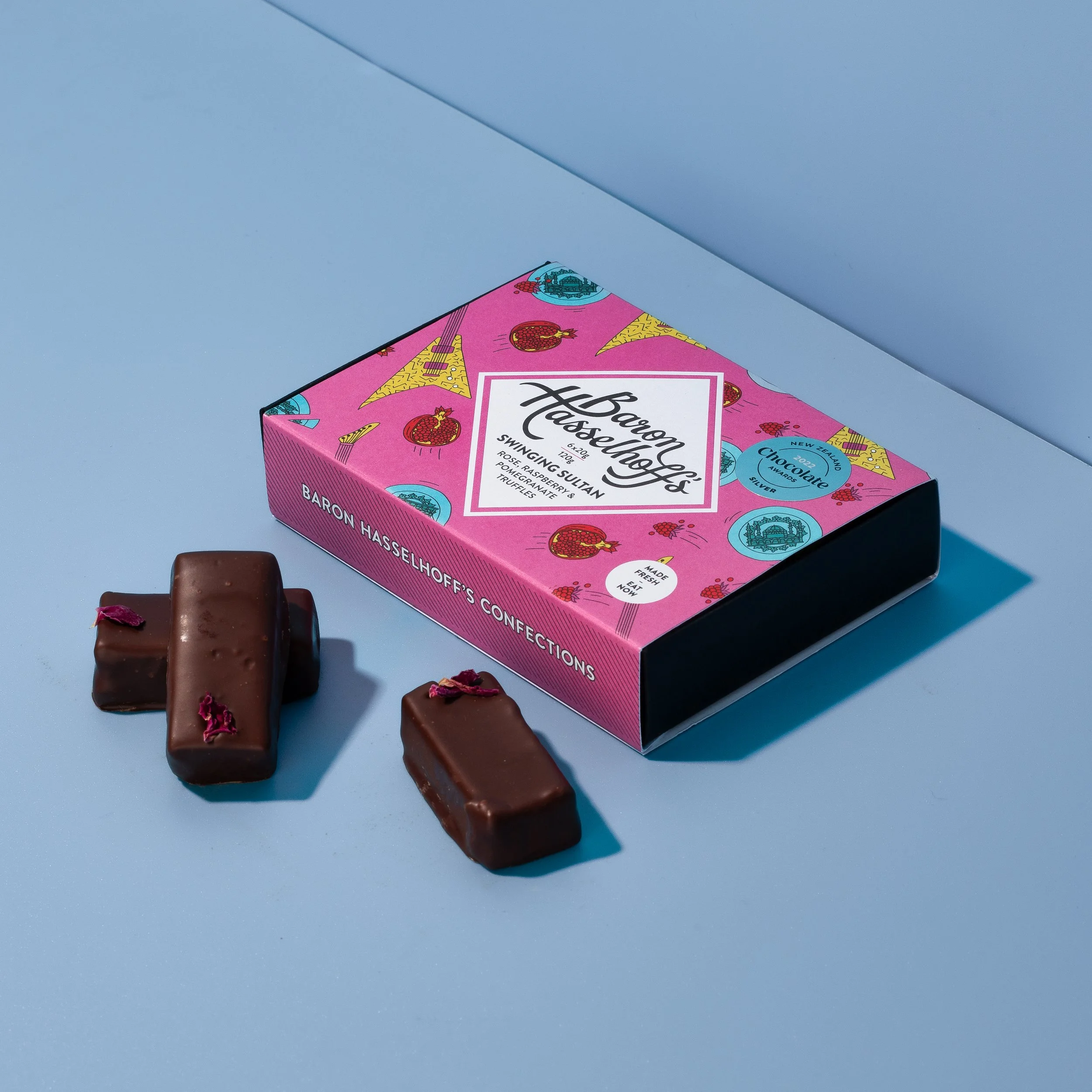 Baron Hasselhoff's Swinging Sultan truffles on a blue background. Studio photography, packaging design, branding, typography, designer. Alice Lloyd.