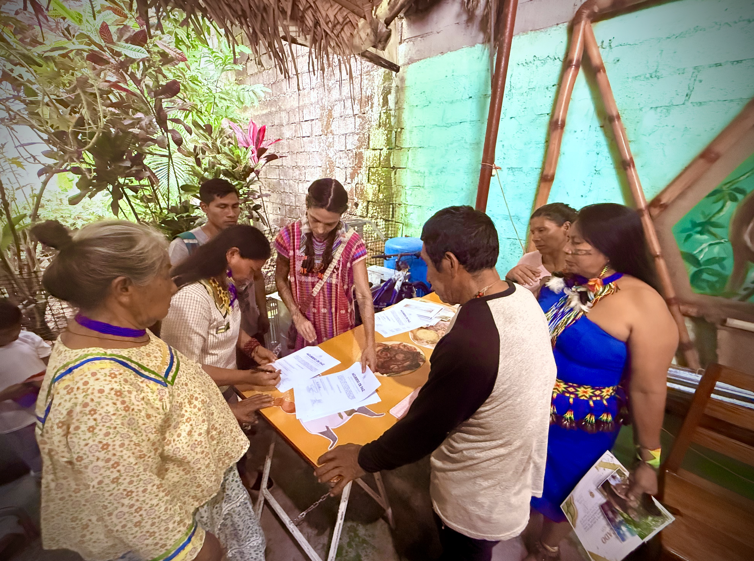 Ixchel working with Kichwa, Waorani, and Shuar tribes in Ecuador.  Members are signing the region's first inter-tribal peace agreement.