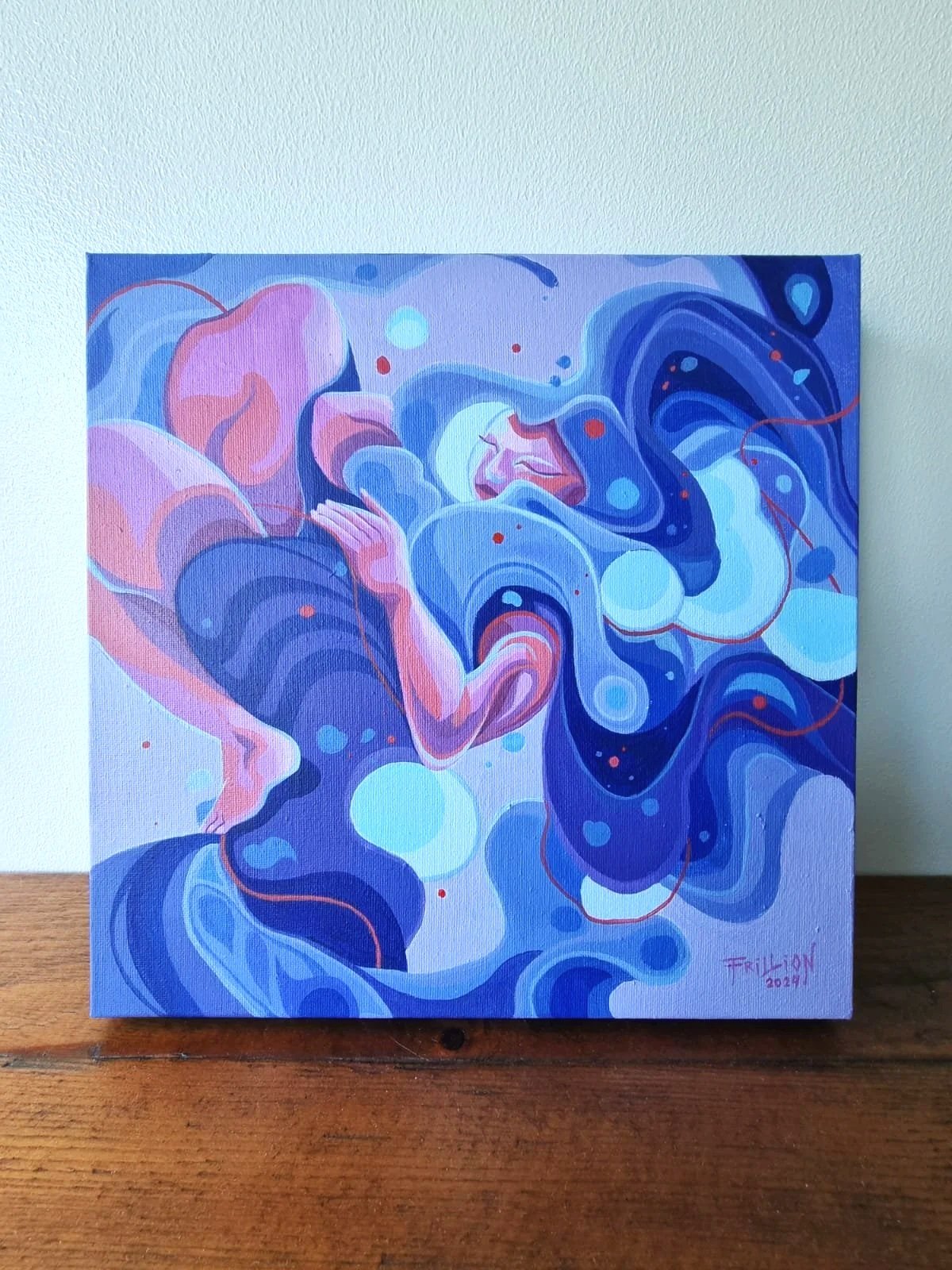 Abstract painting of a woman with long flowing hair, surrounded by swirling blue and pink shapes, with her eyes closed and arms crossed over her chest.