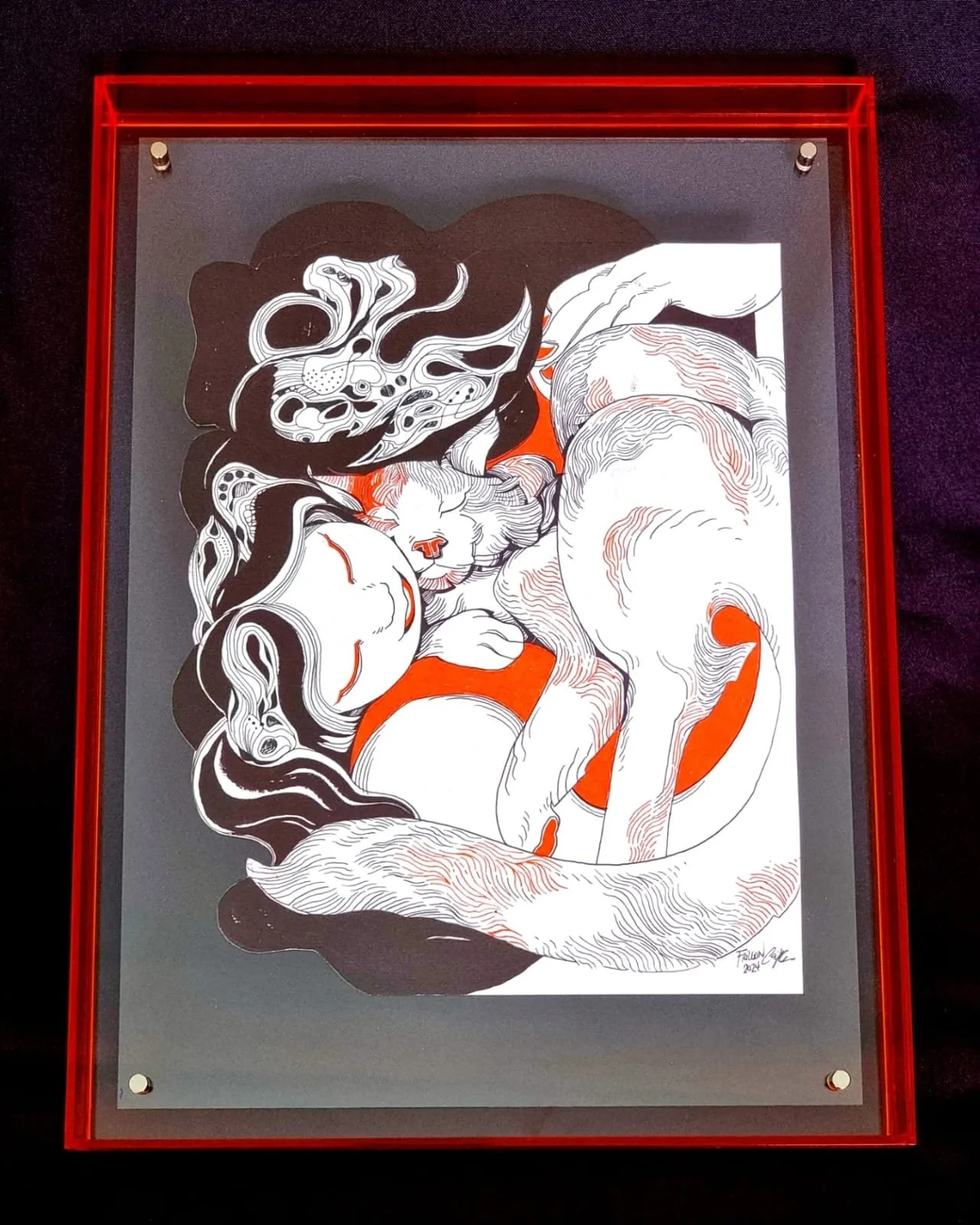 Black and white illustration of a sleeping woman with long hair intertwined with a sleeping cat, set against an orange circle background, framed with a red border.