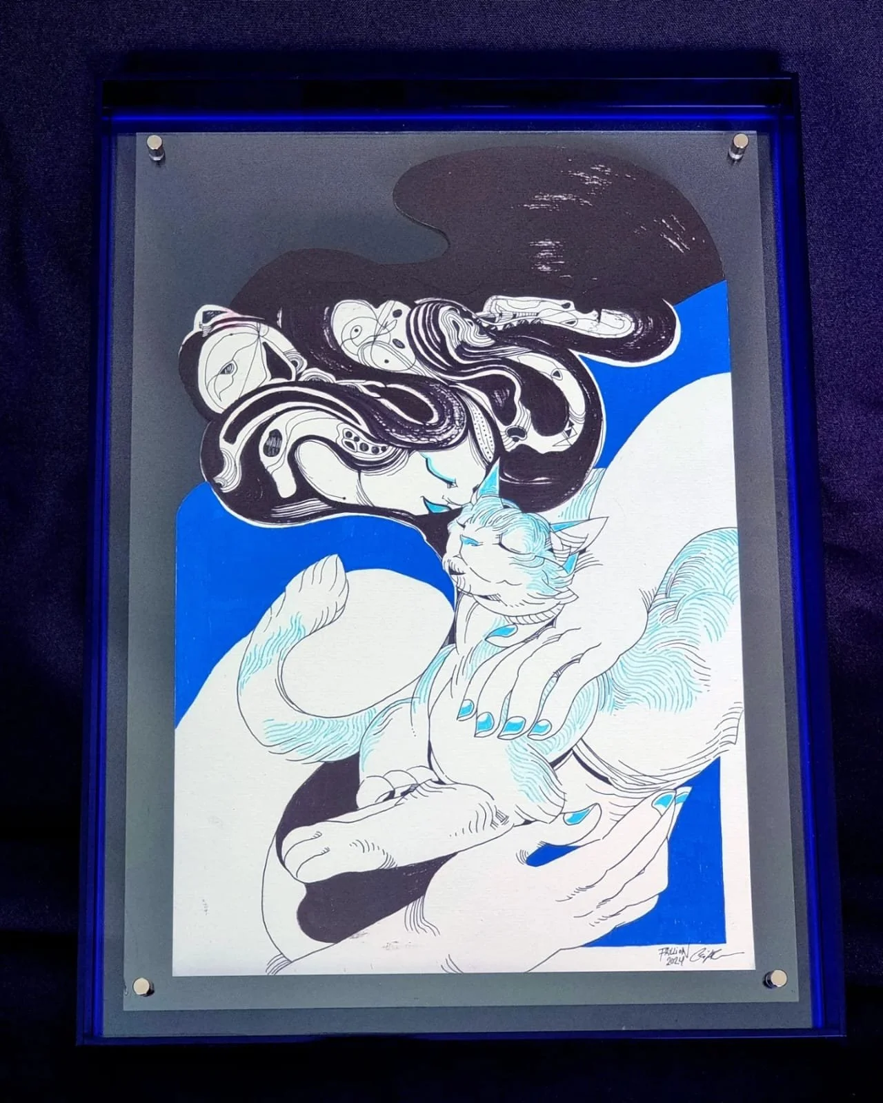 A black, white, and blue ink drawing of a woman embracing a cat, intertwined with swirling black and white hair or smoke, set against a blue background, framed with a blue border.