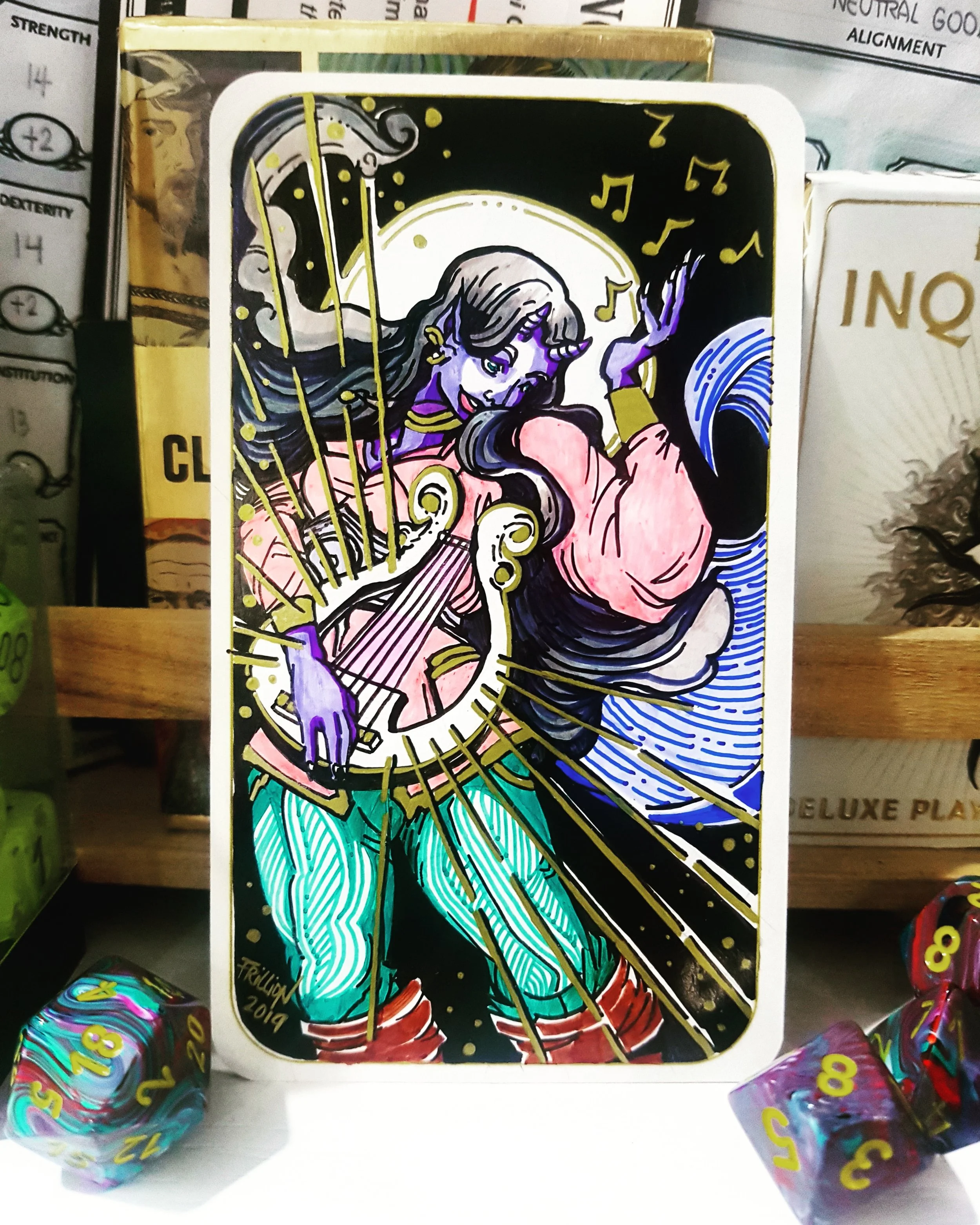 Colorful tarot card featuring a woman playing a guitar, surrounded by musical notes, with a black background and gold accents, displayed on a shelf with multi-sided dice.