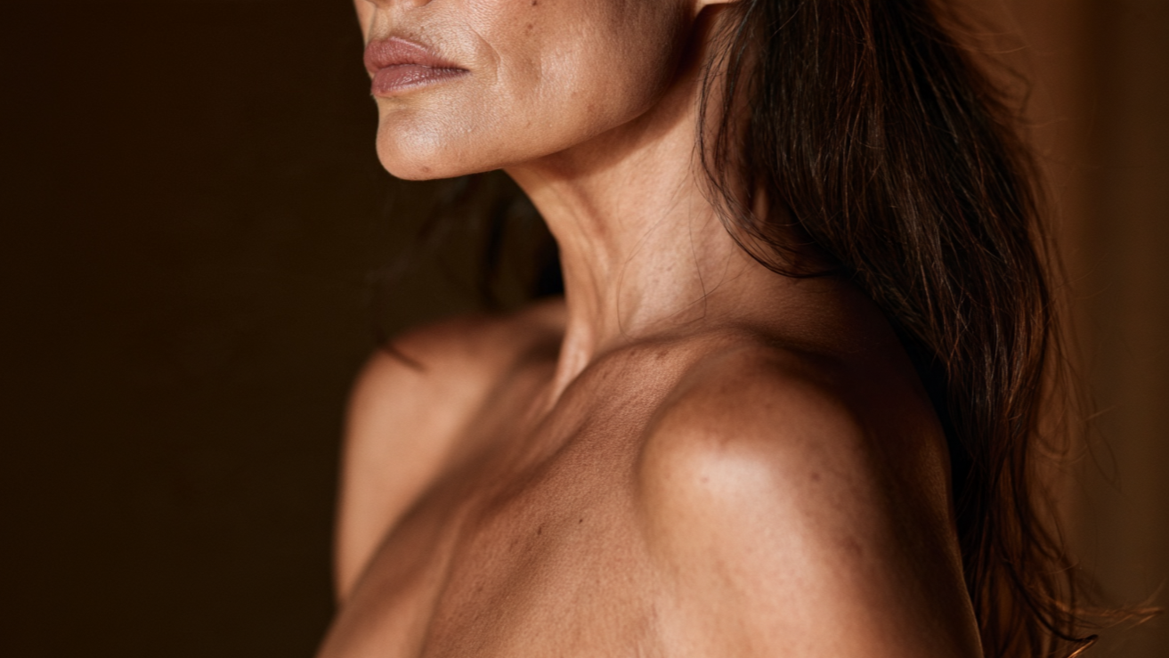Warm editorial portrait of a mature Mexican woman highlighting her natural chin, jawline, and neck contours.