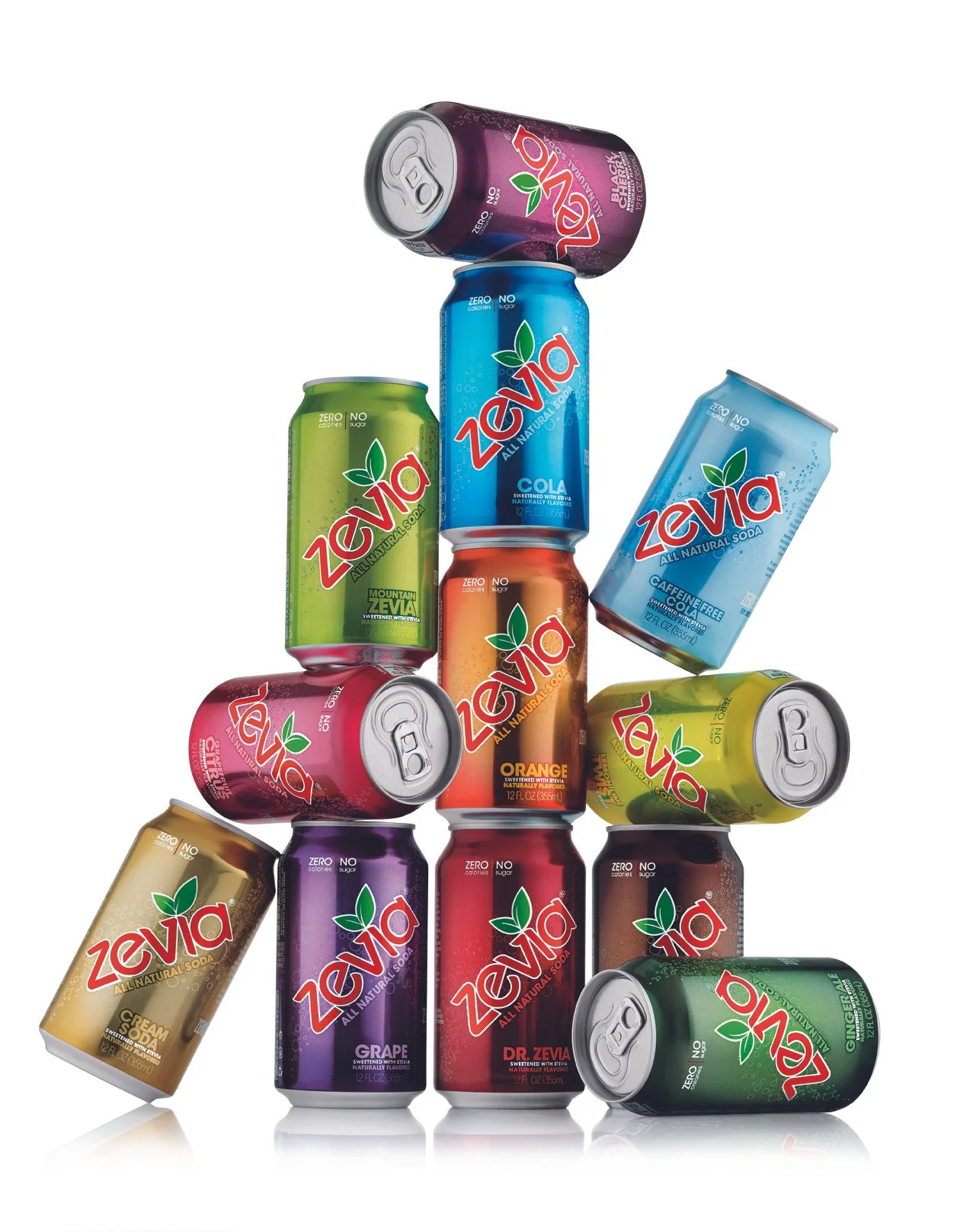 Arrangement of various cans of Zevia soda in different flavors, including cola, orange, grape, ginger, and more, stacked in a pyramid shape.