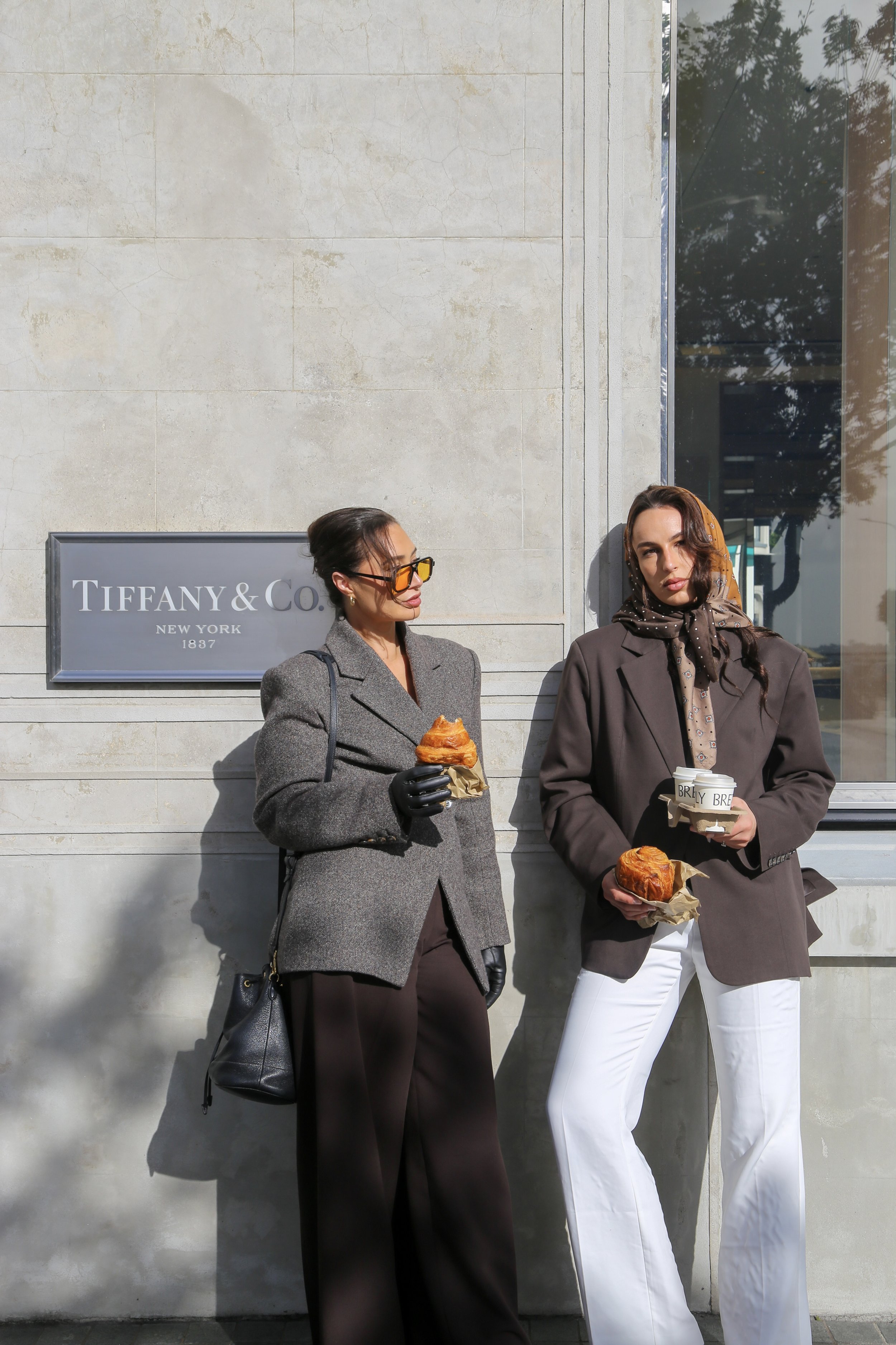 Editorial, chic photograph of co-founders outside Tiffany & Co., recreating the iconic “Breakfast at Tiffany’s” moment with a polished, fashion-forward aesthetic and cinematic styling.