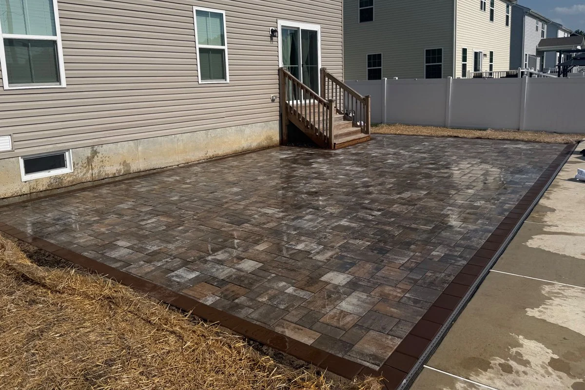 Full view of completed Cambridge Ledgestone paver patio in Stone Harbor Blend surrounding a backyard pool area in Monroe Township, NJ.