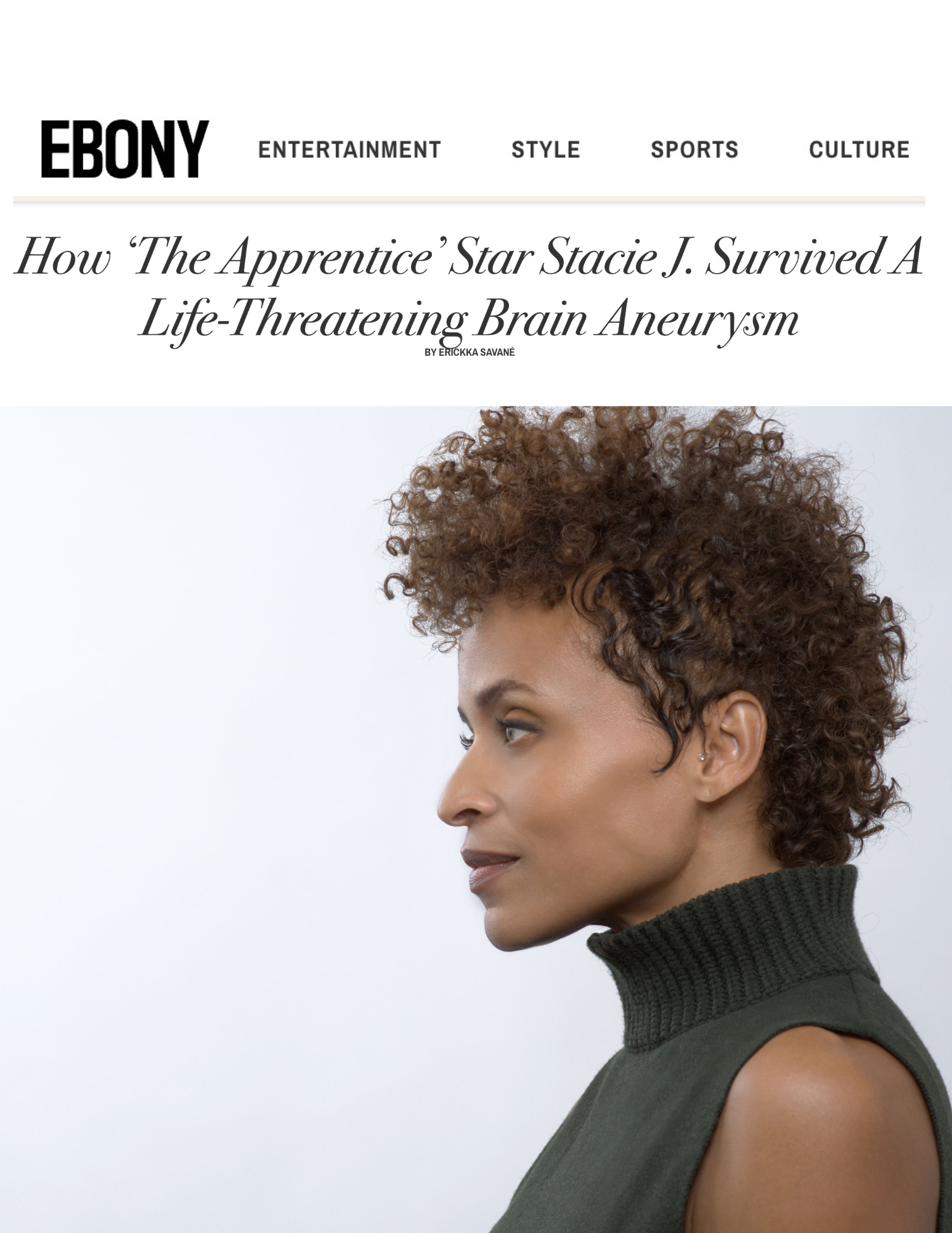 Side profile of a woman with curly hair wearing a black turtleneck vest.