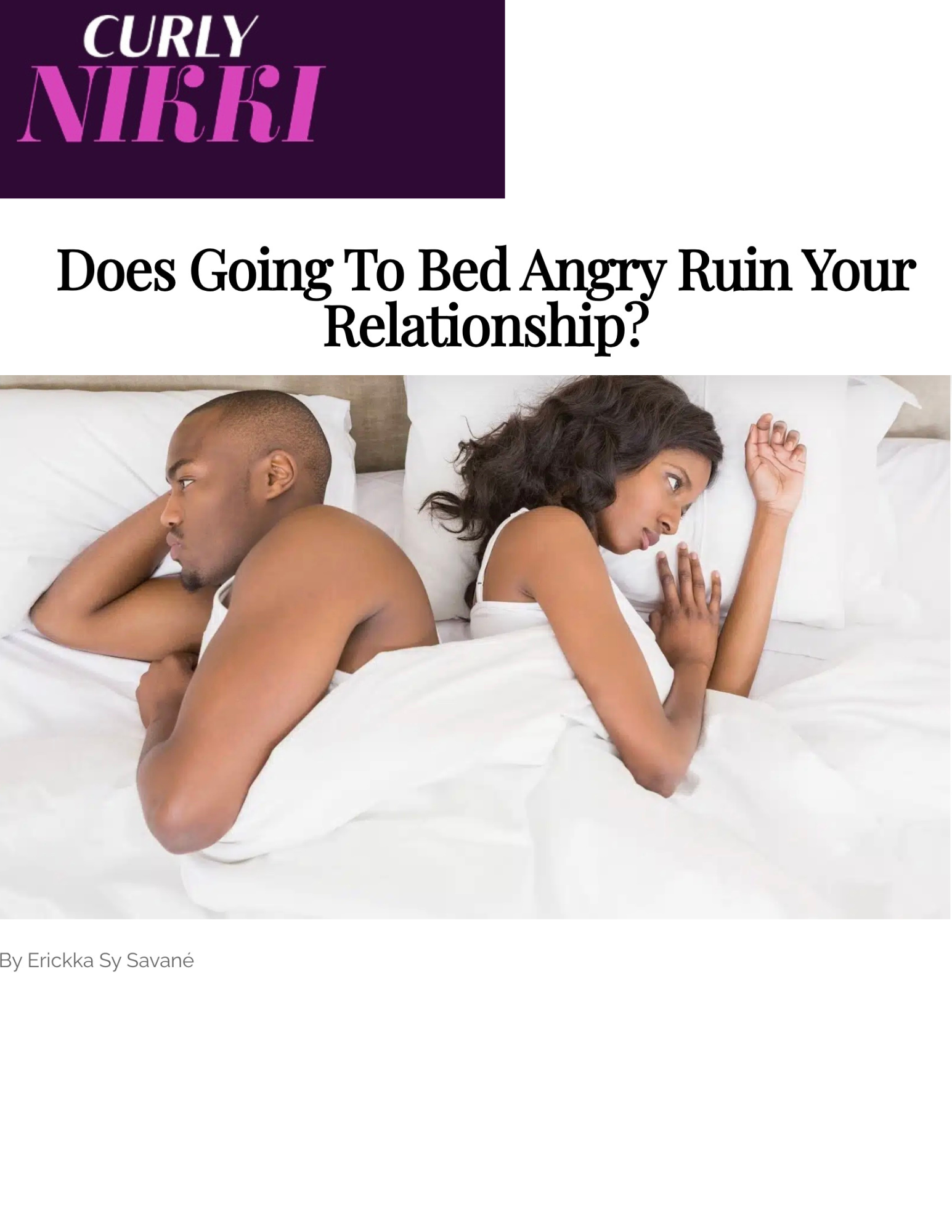 A man and a woman lying back to back in bed, not looking at each other, with a headboard behind them and white bedding.