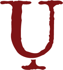Close-up of a red letter 'U' on a black background.
