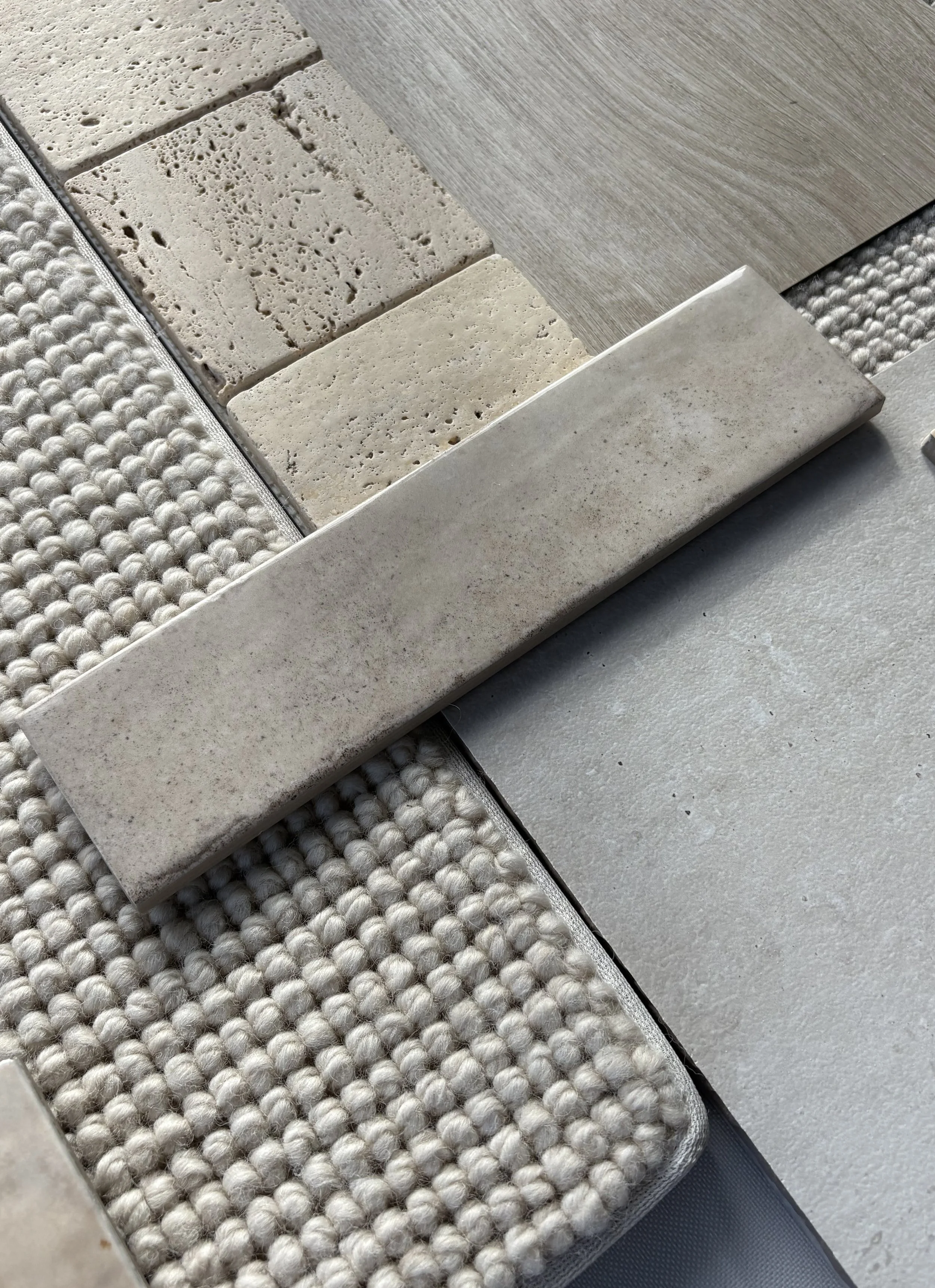 Flay Lay of Neutral Material Swatches Including Carpet and Tiles