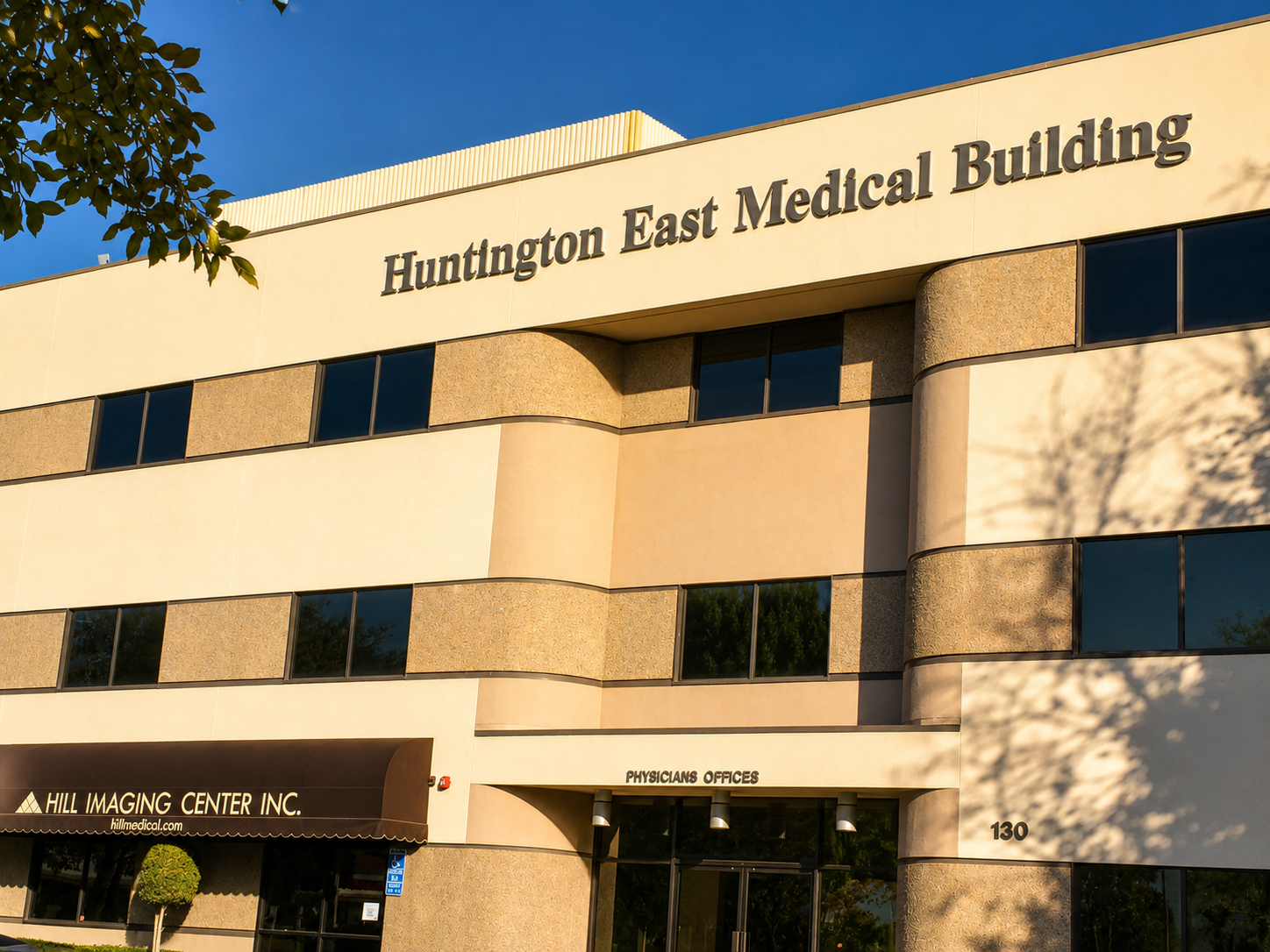 Exterior of Huntington East Medical Building with a sign indicating physicians' offices and a Hill Imaging Center sign at the entrance.