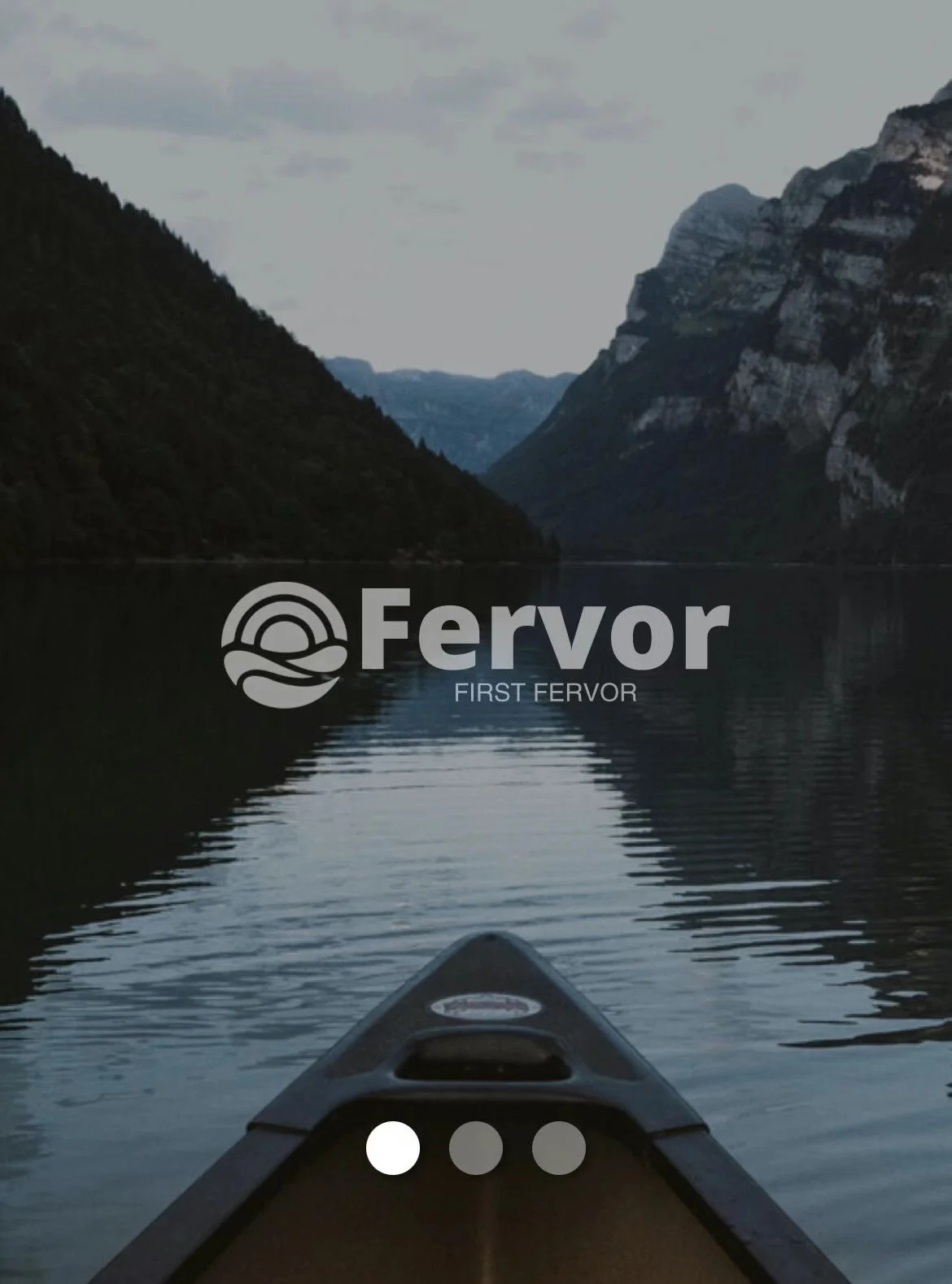 View from a kayak on a calm river between steep mountain cliffs, with overcast sky, and the logo 'Fervor' and the text 'First Fervor' overlaying the image.