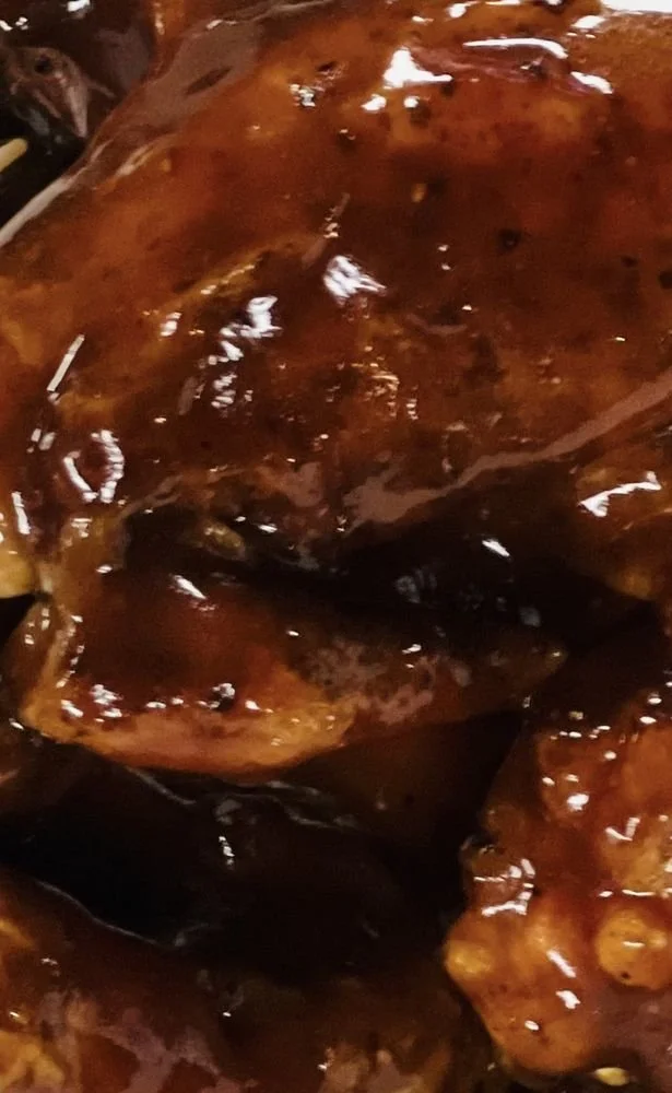 Close-up of glazed or caramelized sliced sweet potatoes or yams.