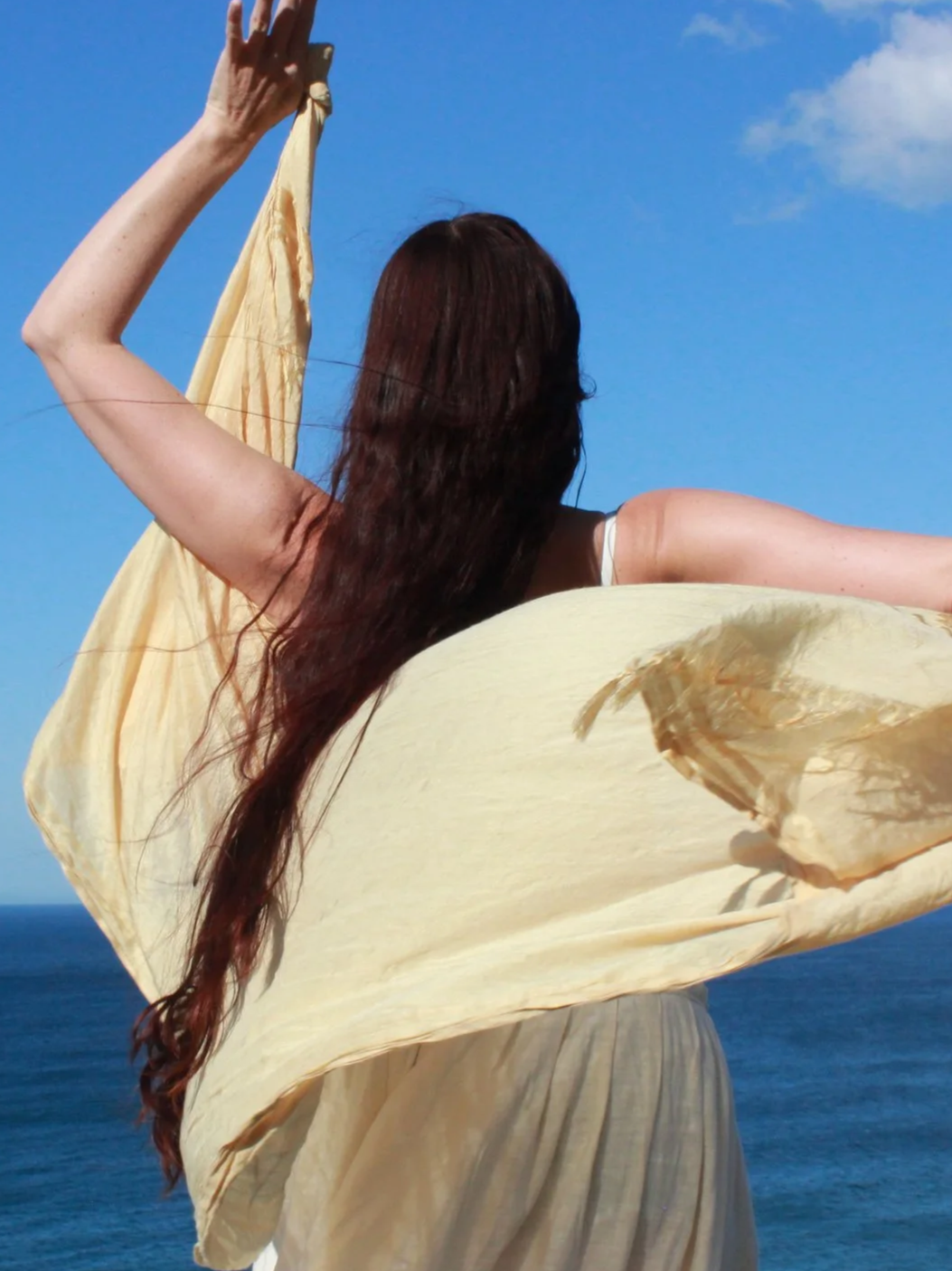 sky ocean shawl arms up in motion.png