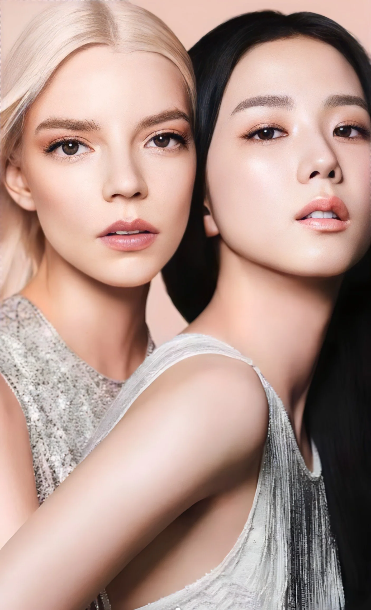 Close-up of two women with makeup, one with blonde hair and the other with black hair, wearing silver dresses, in a pose with close facial expressions.