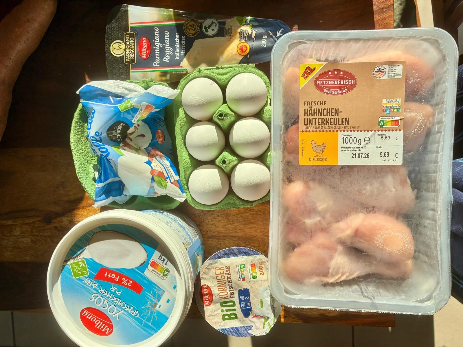 Protein and dairy products from Lidl including Milbona Greek yoghurt, mozzarella, Parmigiano Reggiano, organic cottage cheese, eggs, and fresh chicken