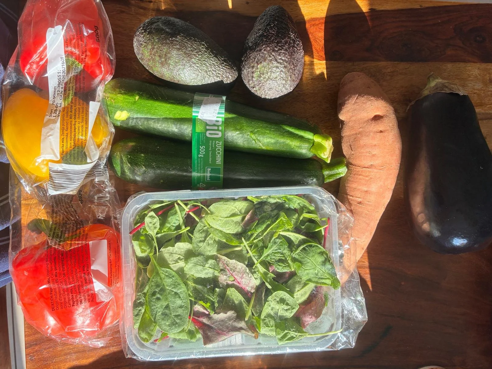 Fresh vegetables from Lidl including peppers, zucchini, avocados, spinach, sweet potato, and eggplant