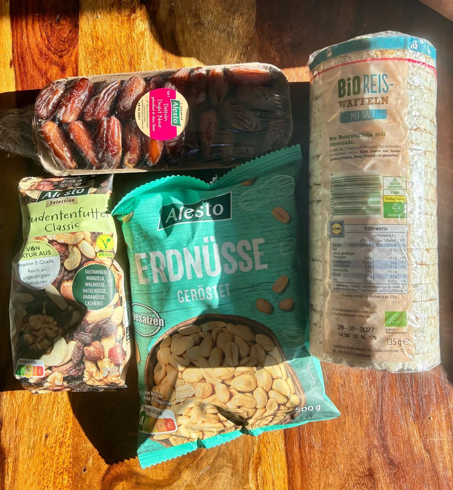 Gluten-free snacks from Lidl including Alesto dates, roasted peanuts, trail mix, and organic rice cakes