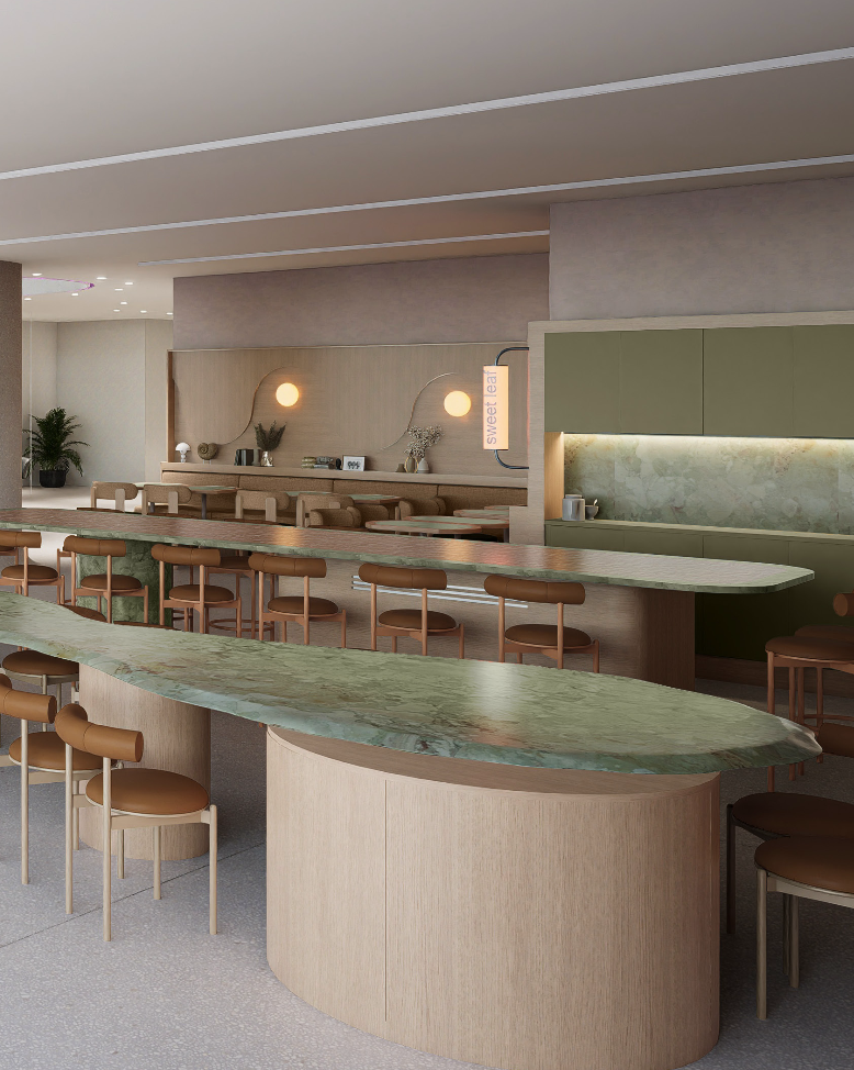 Modern cafe interior with curved green marble countertops, wooden bar stools, and a cozy seating area with wall-mounted lamps and decorative plants.