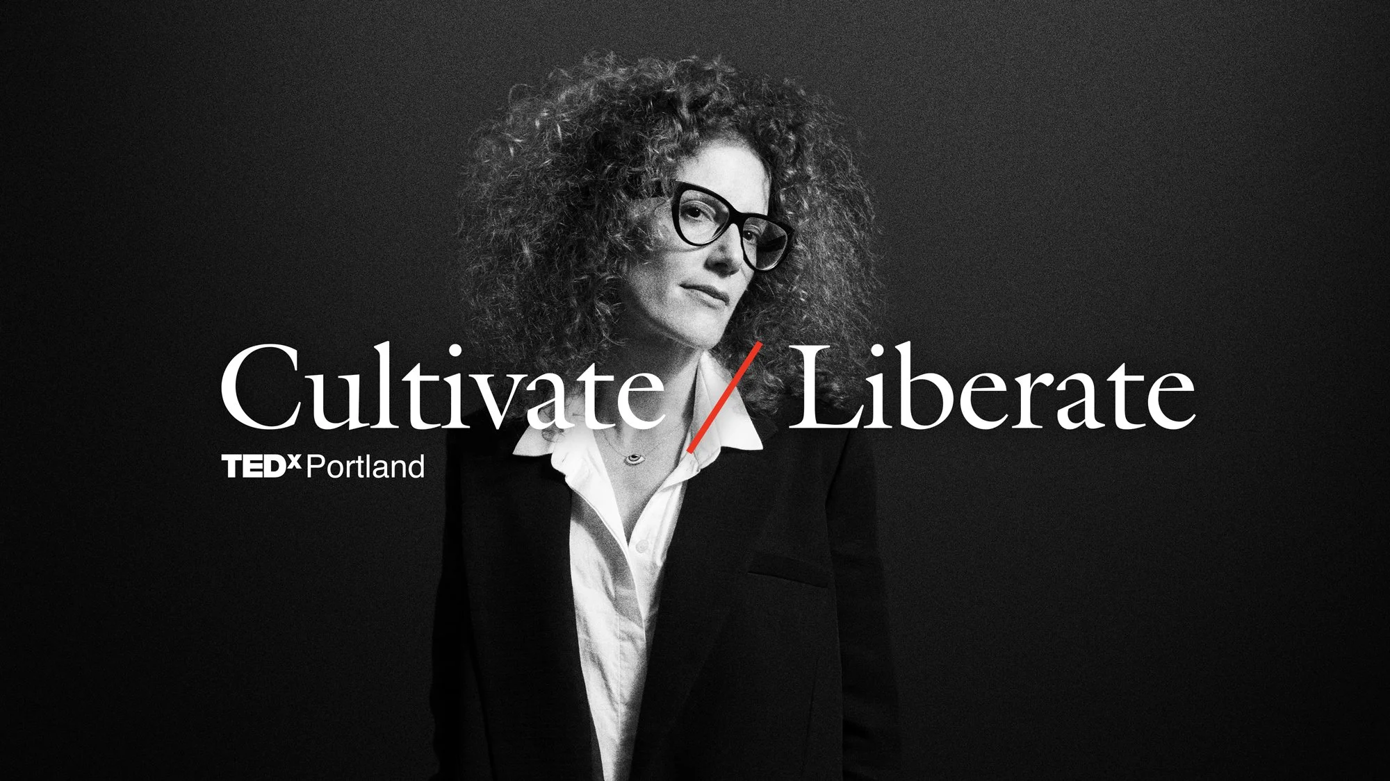 Black and white promotional poster for TEDxPortland featuring a woman with curly hair and glasses, wearing a black blazer and white shirt, with the words "Cultivate / Liberate" displayed prominently.