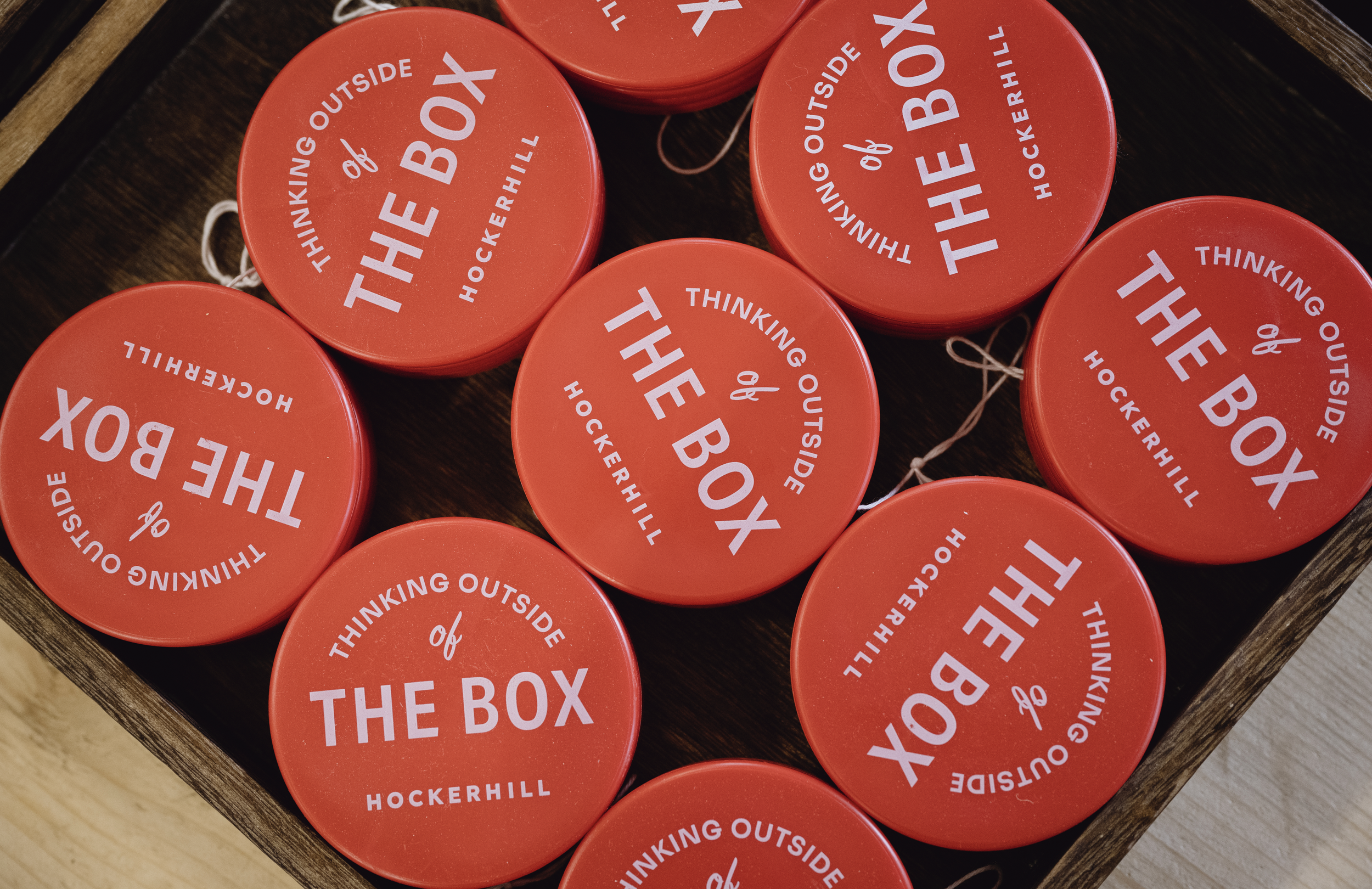 Bright red branded yo-yos in the Hockerhill gift shop featuring playful typography and witty wordplay.