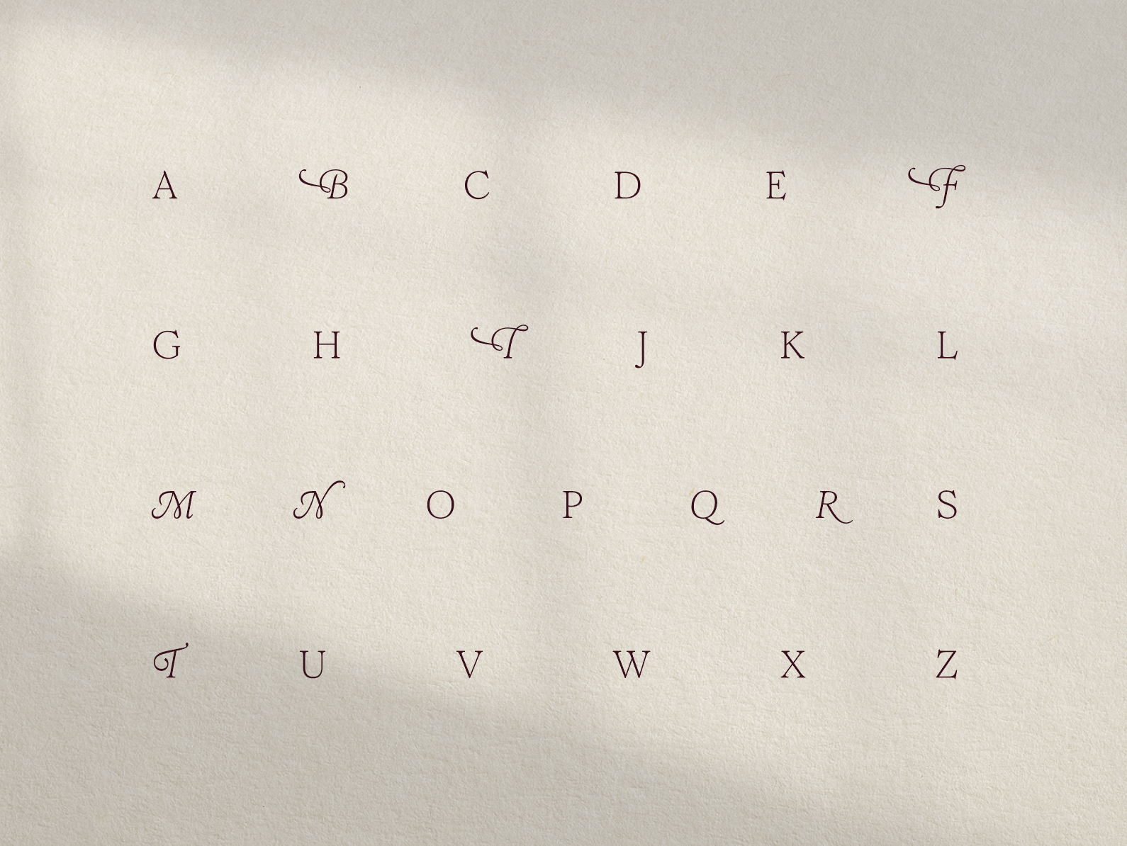 Pomelo's elegant, flourishing typeface alphabet printed on premium textured paper.