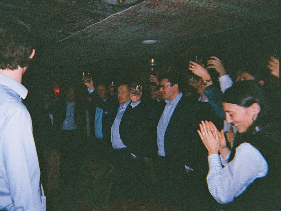 Vintage-style candid photograph showcasing guests socialising at a Wolfschmidt event.