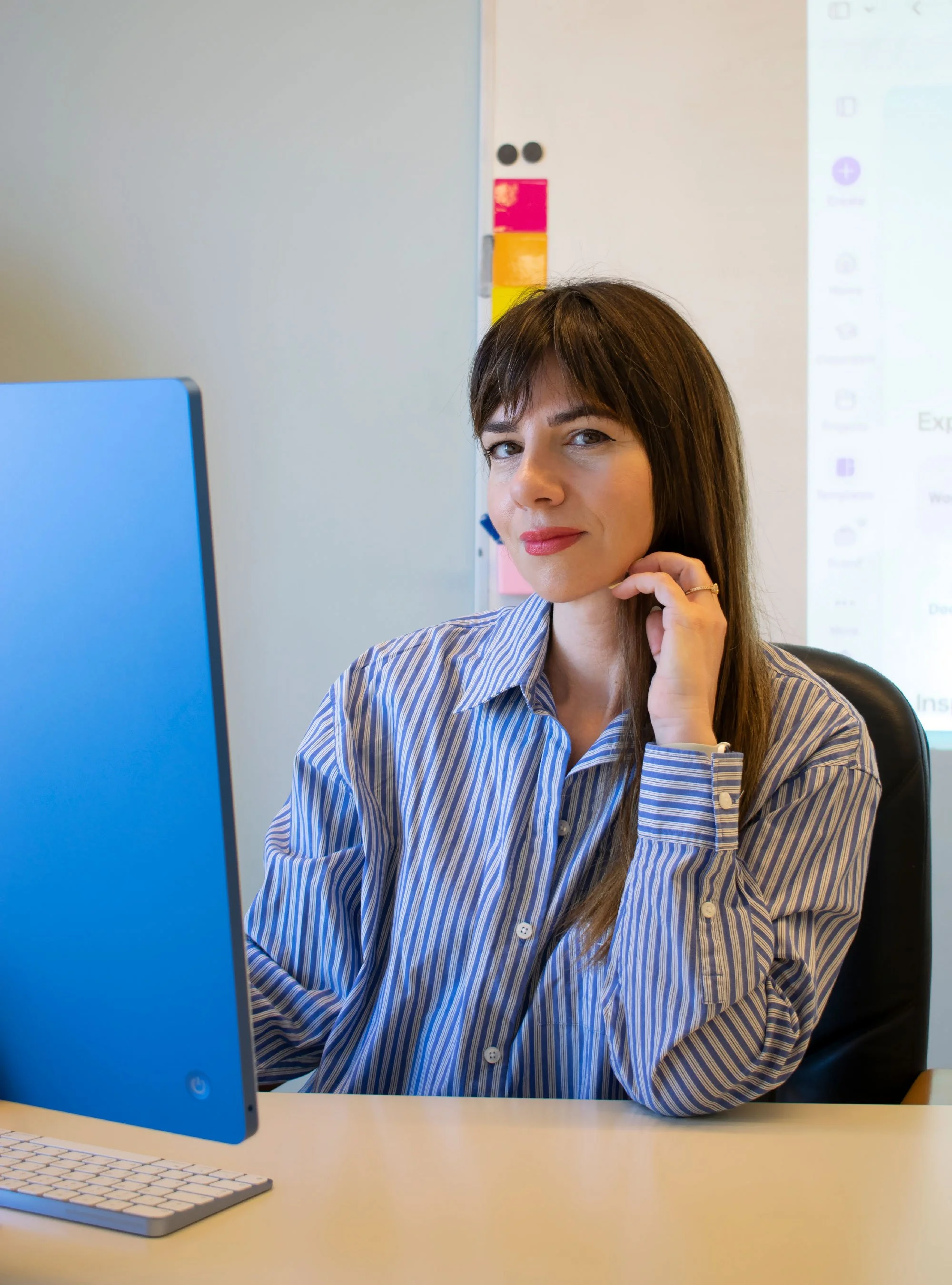 Ioanna Karava, founder of Hello Bridge Academy, seated at her desk in the classroom.