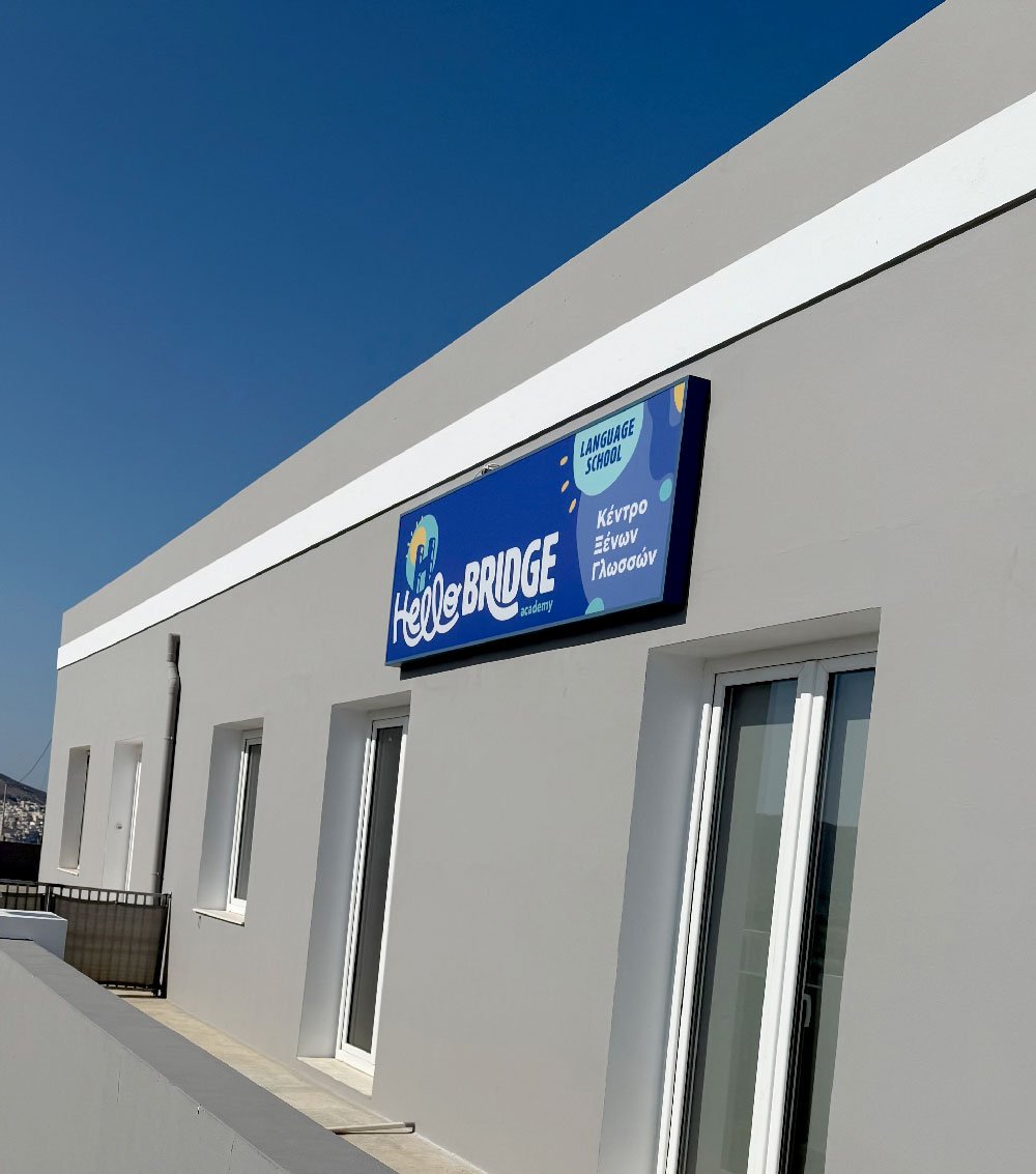 Exterior of Hello Bridge Academy language school in Syros with the school sign on the building.