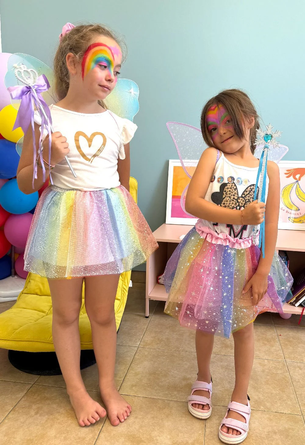 Two young students dressed in colourful costumes during a creative activity at Hello Bridge Academy.