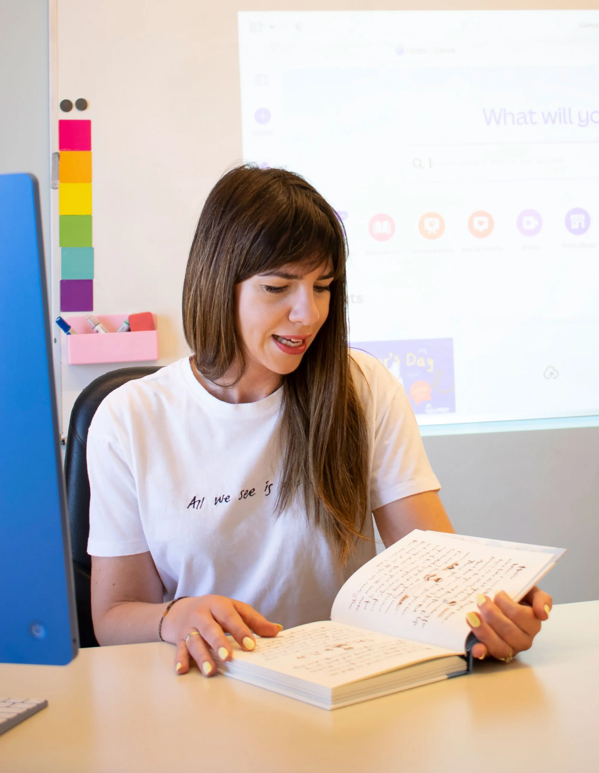 Ioanna Karava, founder of Hello Bridge Academy, reading from a book during a language lesson.