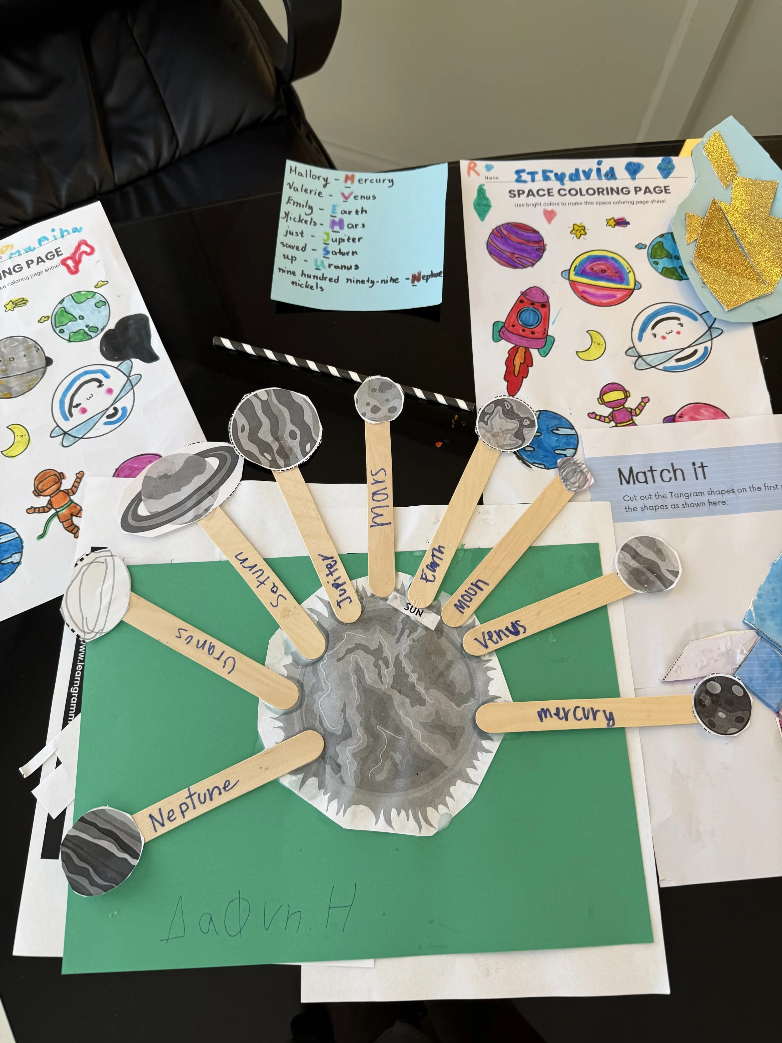 Colorful space-themed educational project about planets and planets names, with hand-drawn illustrations, paper planets, and labeled wooden sticks showing planets like Mercury, Venus, Earth, Mars, Jupiter, Saturn, Uranus, Neptune, and Mercury again.