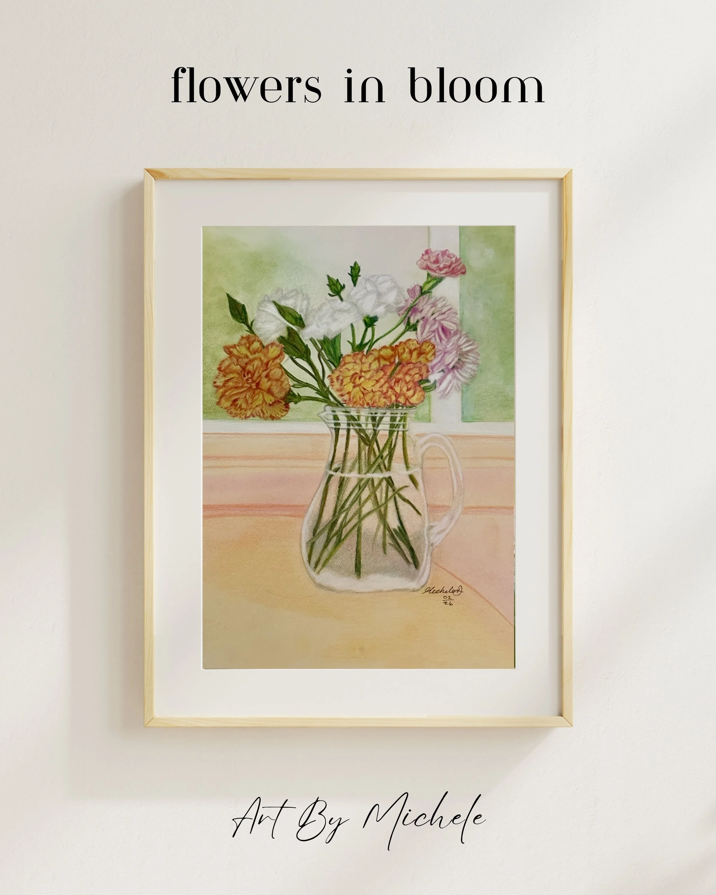 A framed watercolor painting of a bouquet of flowers in a glass pitcher, with a light green background and a wooden frame hanging on a white wall. The image features the text 'flowers in bloom' above the painting and 'Art By Michele' below.
