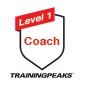 A logo with a shield shape, featuring a red ribbon at the top that says 'Level 1'; below it, the word 'Coach' is written in red. This is proof of a TrainingPeaks Level 1 Accreditation