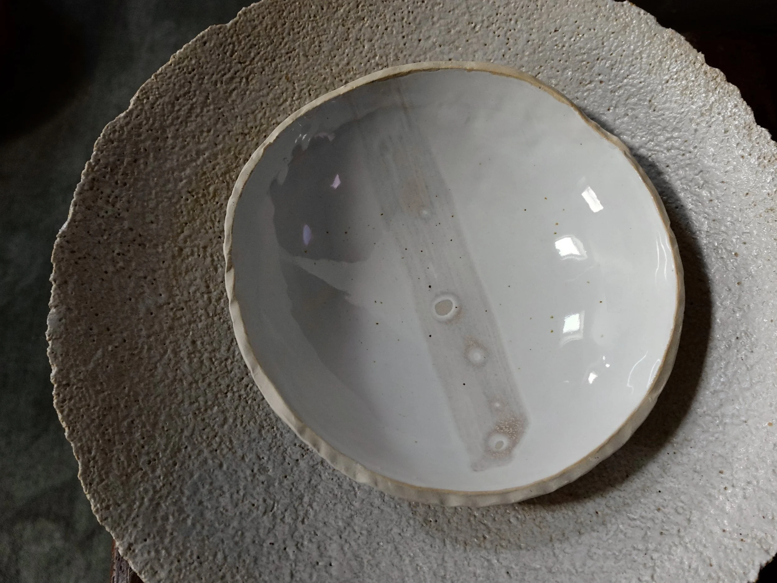 Finished bowls photographed against the large textured ceramic platter