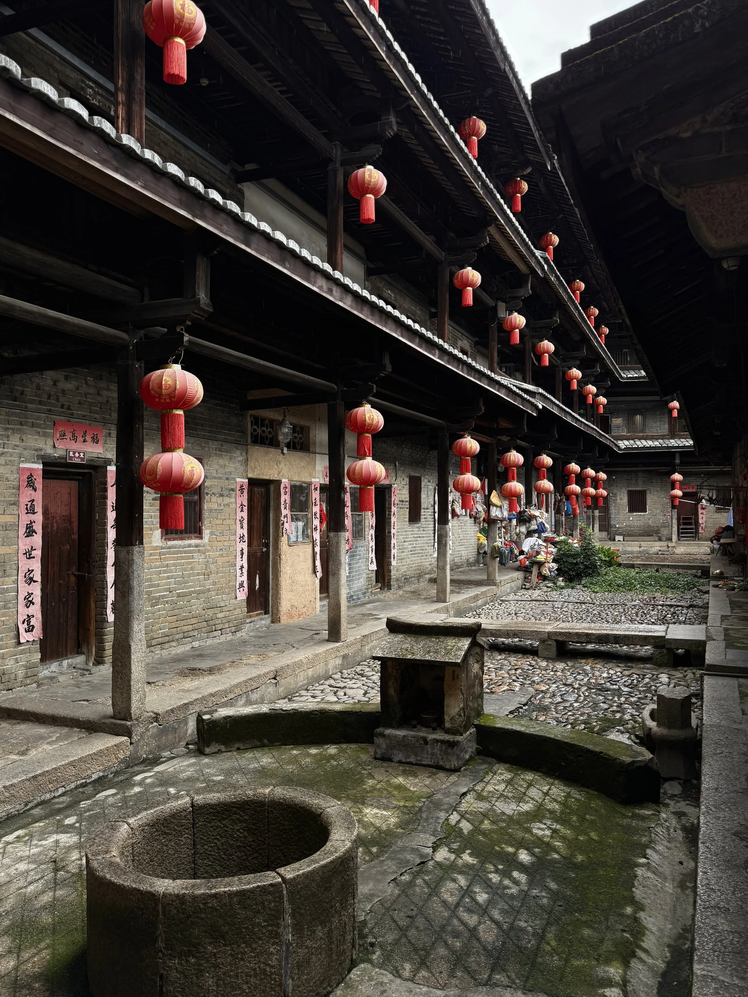 Circular stone well set within one of the internal courtyards of Tai’an Lou in Dabu.