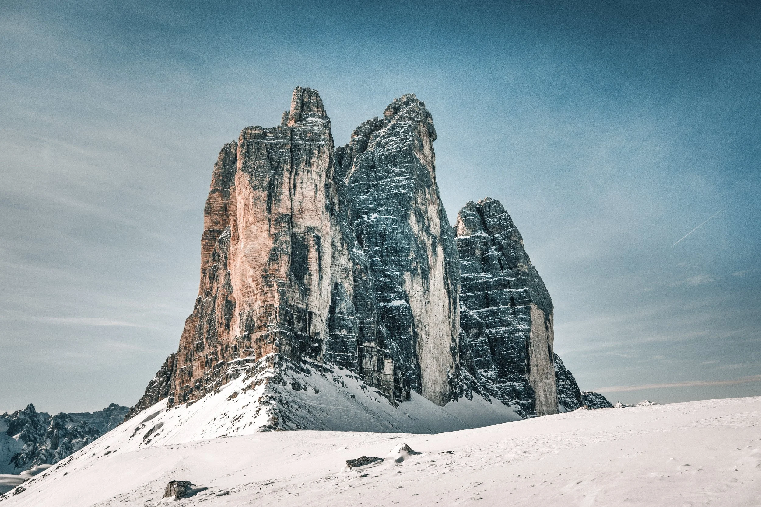 Snow-covered mountain peaks with a clear sky in the background.