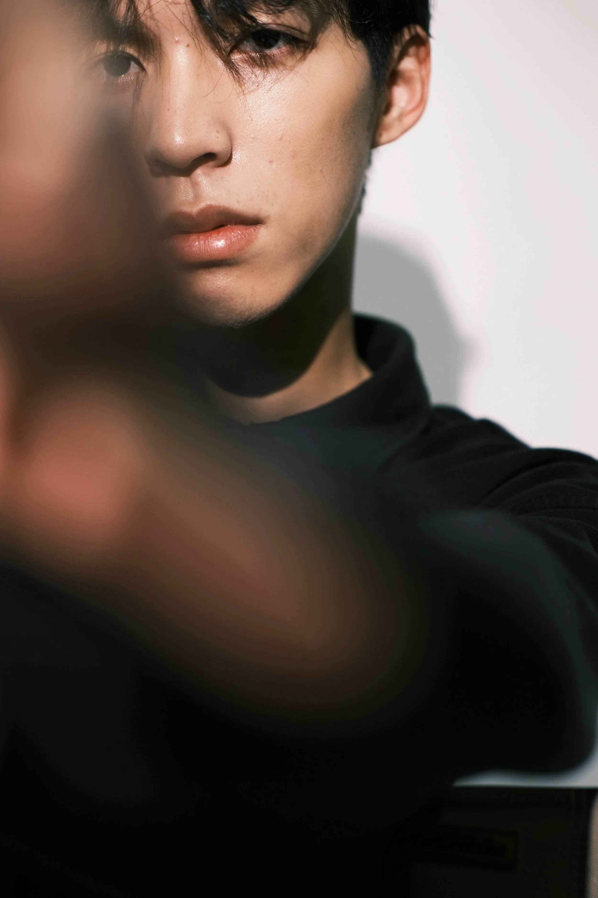 Close-up portrait of a young man with clear skin in natural light — LED light therapy at Skinor, Chelsea SW3