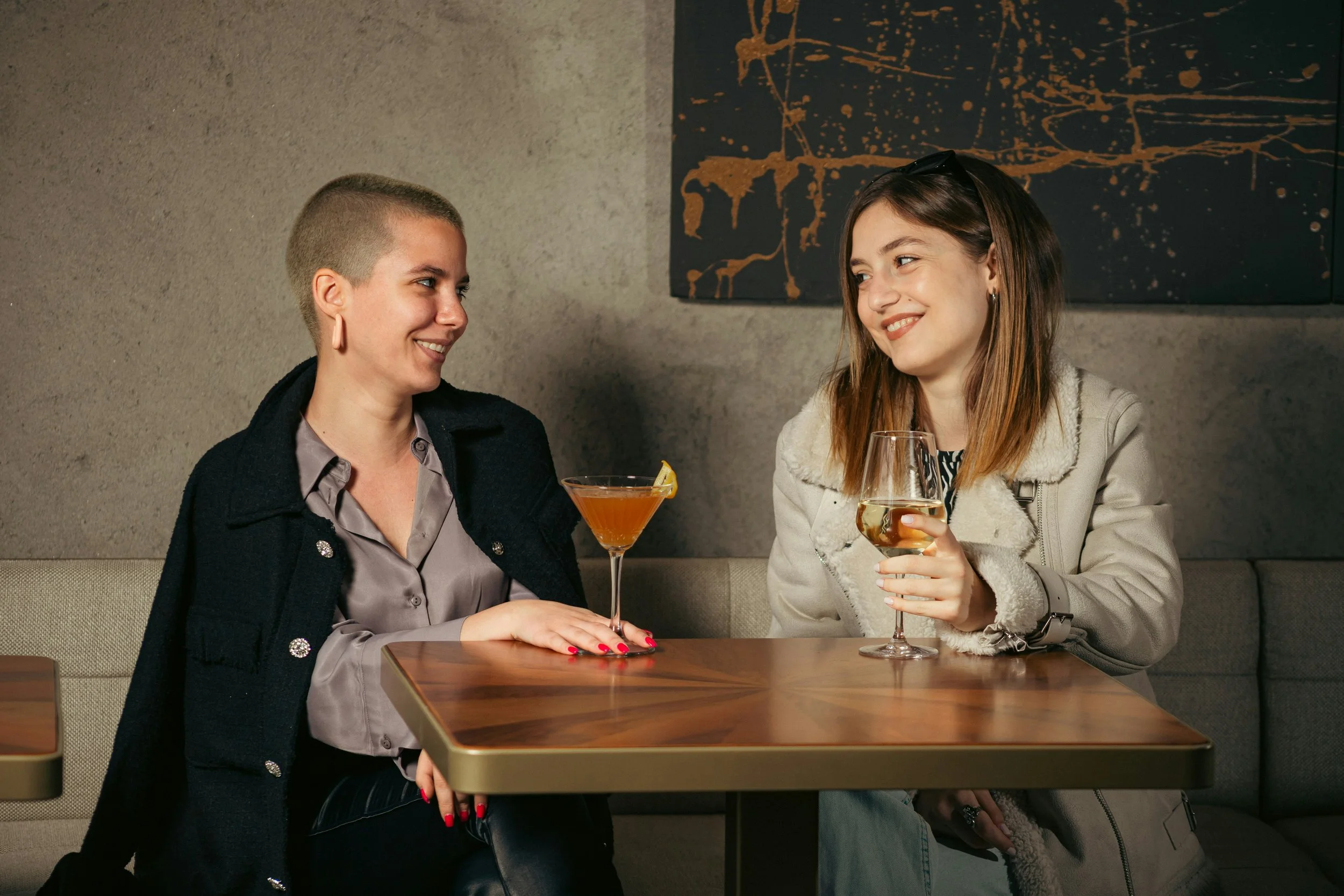 Two women laughing together — refer a friend offer at Skinor, Chelsea SW3