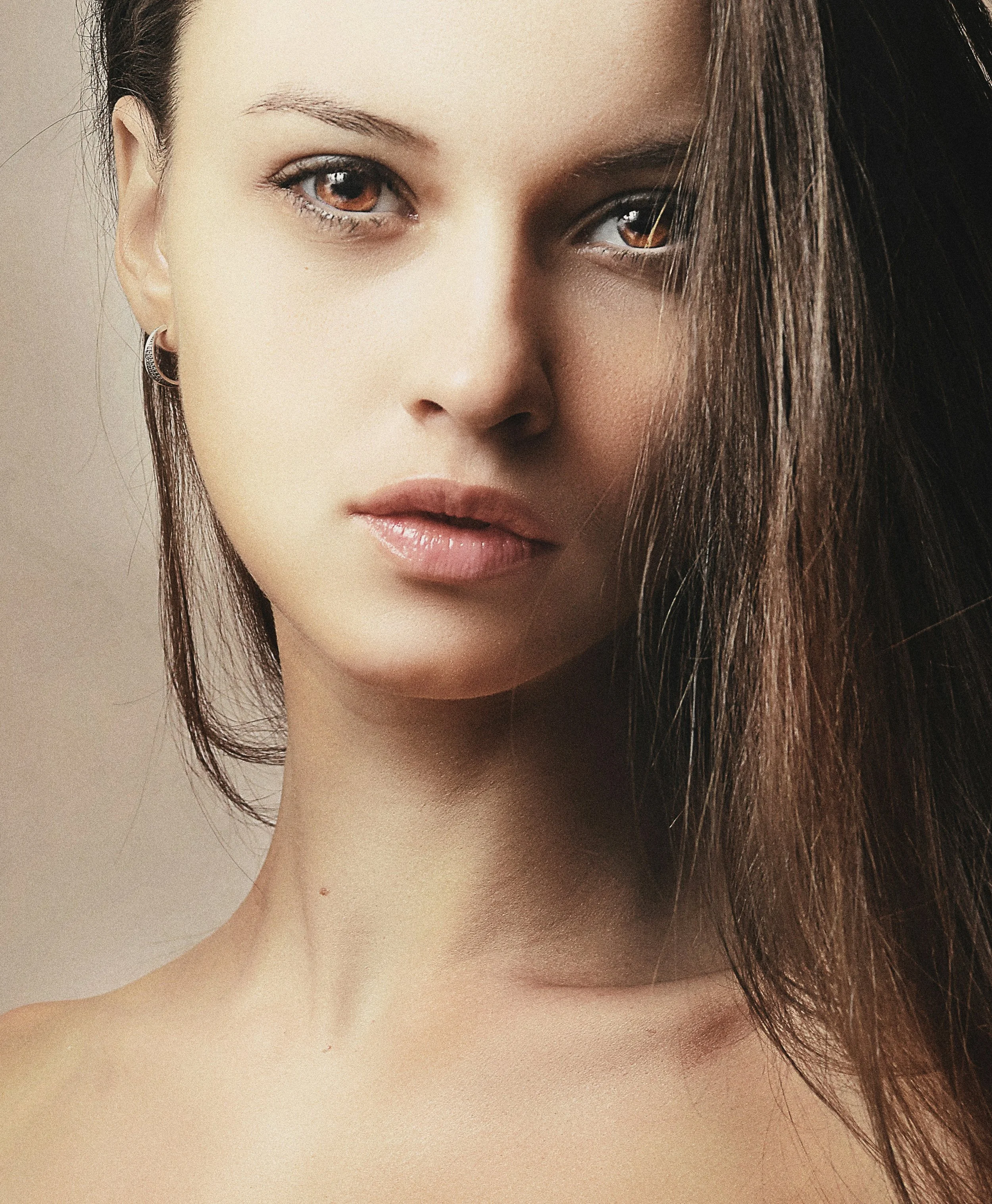 Woman with dark hair in natural light — bespoke facial treatments at Skinor, Chelsea SW3